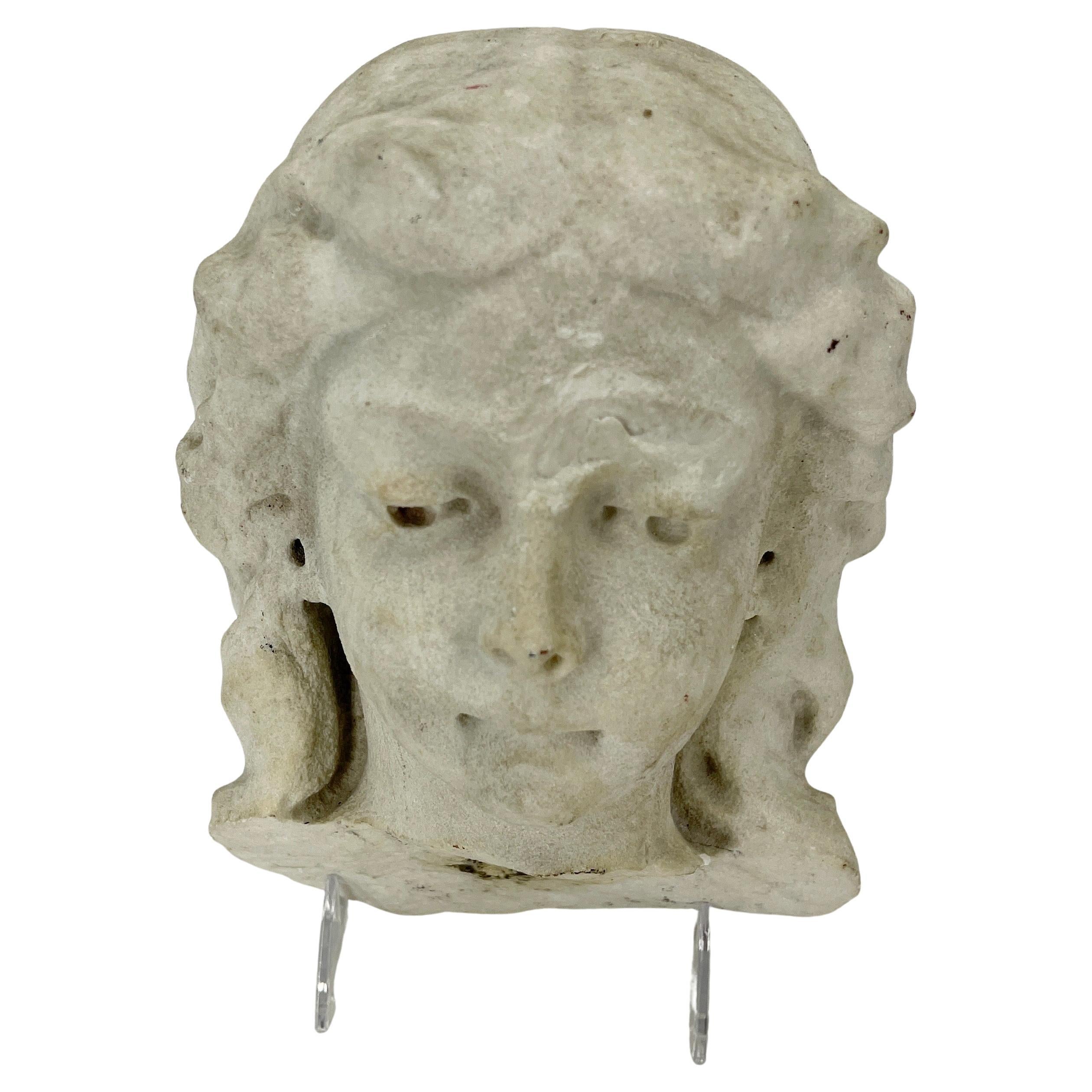 Neoclassical style stone fragment of a ladies head.
