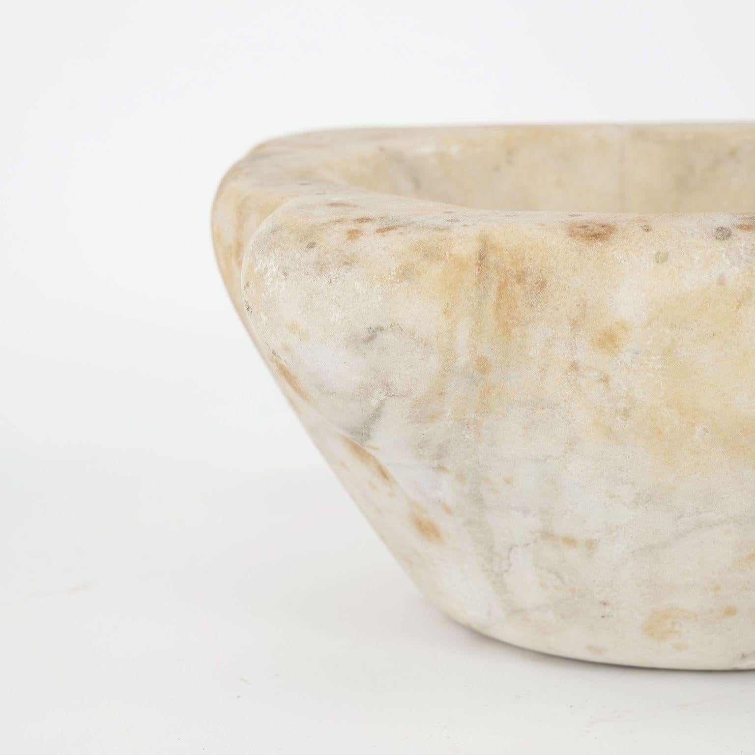 19th century stone mortar from France. Hand-carved alabaster mortar in a conical shape with four handles. One handle notched with a channel for pouring. Beautiful as a sculptural accent piece or decorative bowl. Seven stone mortars of varying shapes