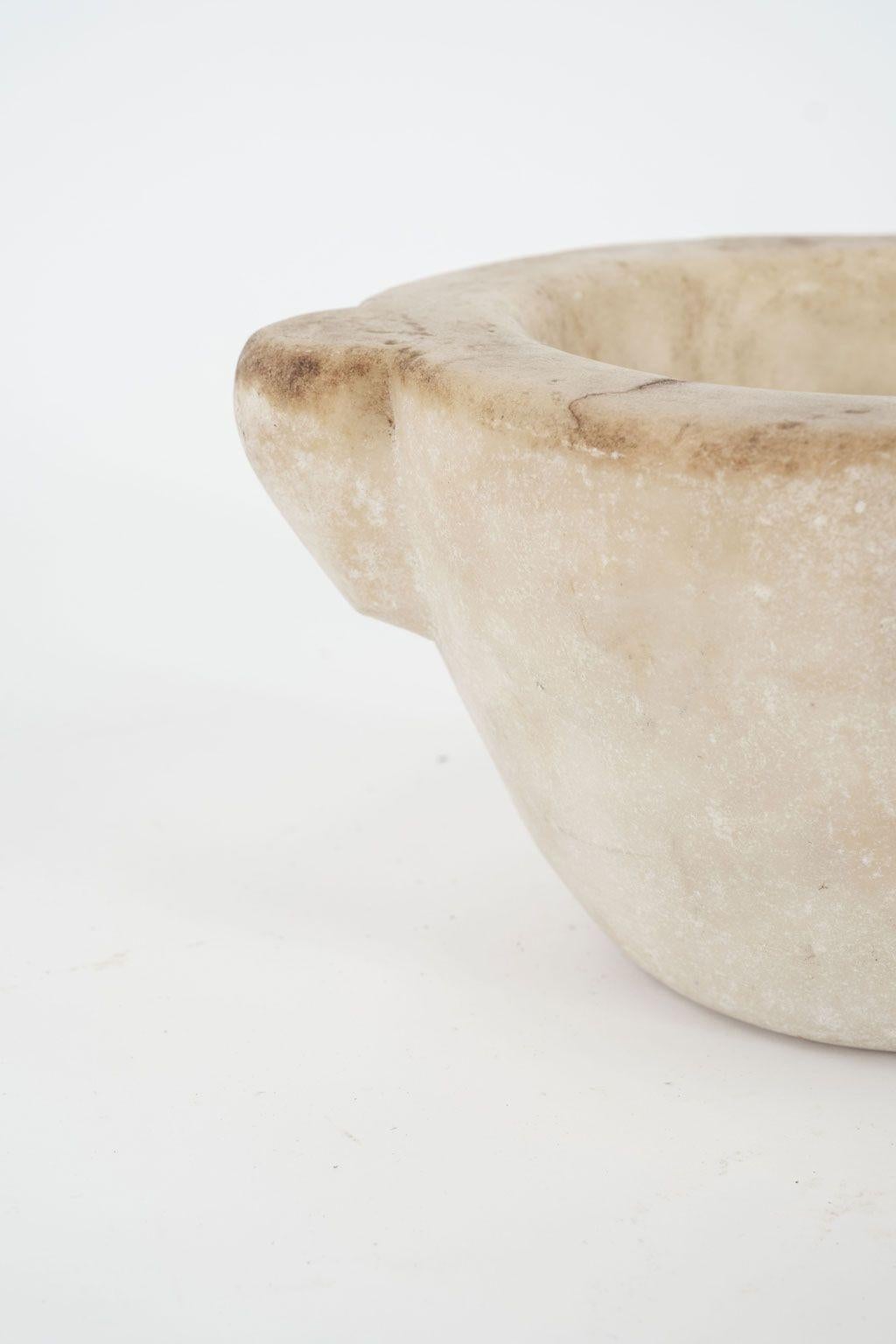 19th century stone mortar from France. Hand-carved alabaster mortar in a conical shape with four handles. Beautiful as a sculptural accent piece or decorative bowl. Seven stone mortars of varying shapes and sizes are available (see last image). All