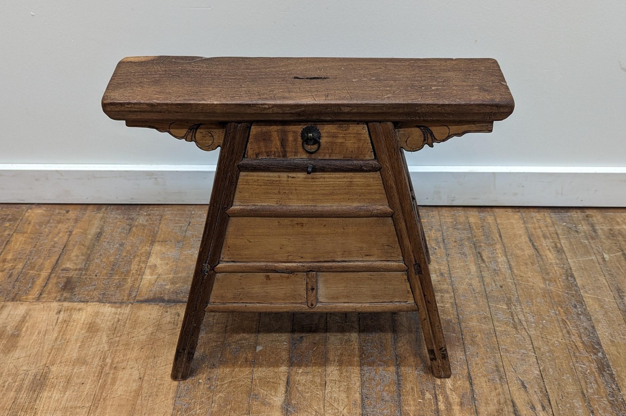 19th century Chinese Stool. This is an antique Barber stool.  Natural wood stool of Elm wood & Poplar.  The stool has one small drawer in the front, and two larger drawers on the side. The seat has a hole in the middle of the top which is where