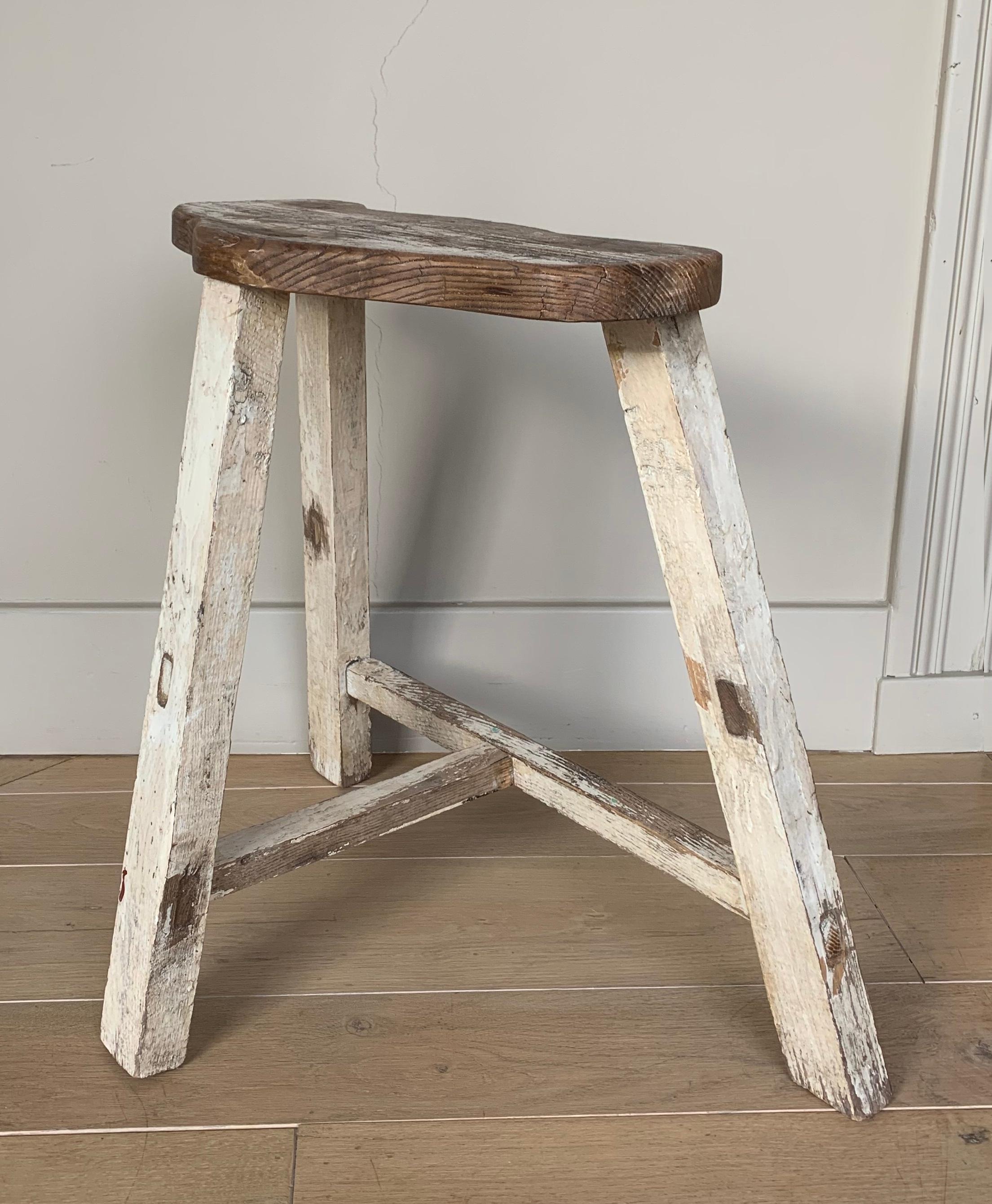 A 19th century mountain stool with the original faded cream paint remains. As easthetic pleasing as functional thing to have in your home.