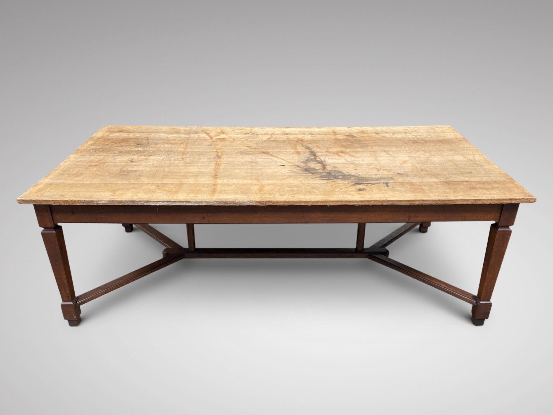A stunning antique 19th century oak Hayrake Farmhouse work or dining table. A solid pale coloured oak plank top supported by a very sturdy base with a centre stretcher base frame. All standing on four square tapering legs united by 