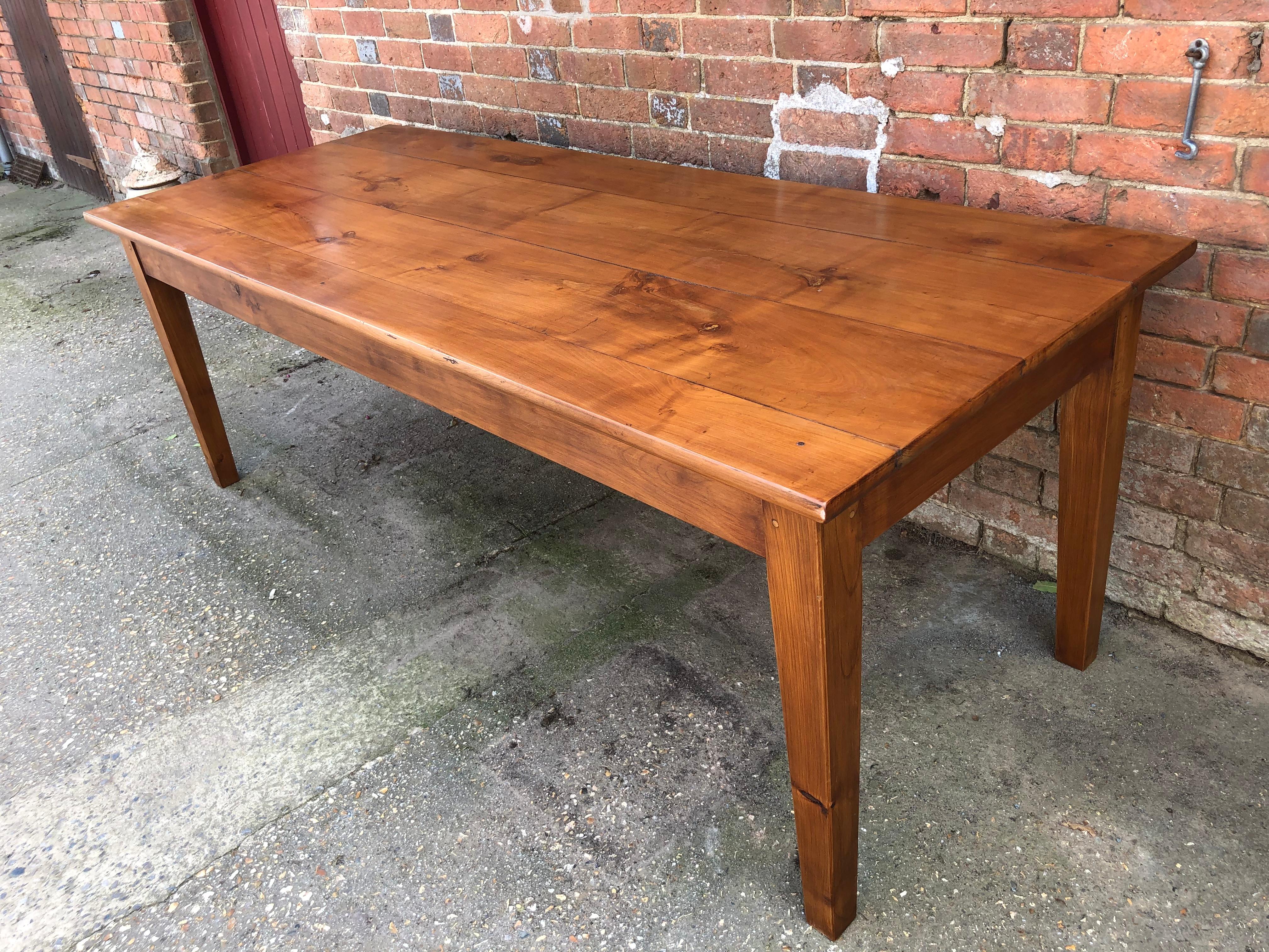 Well proportioned solid cherrywood French farmhouse table on square tapering legs, of good color and figuring.