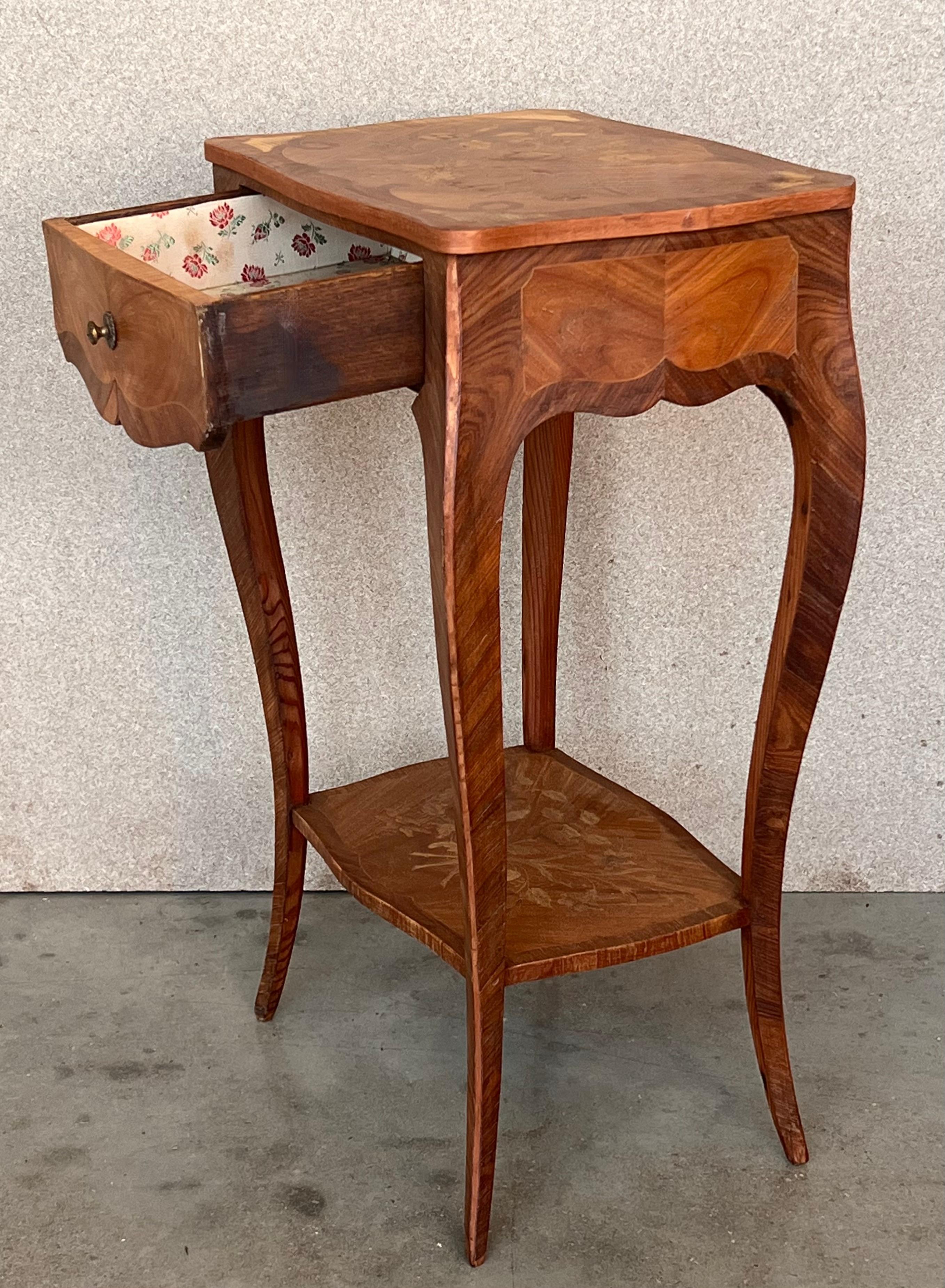 A very fine Louis XV French Style side tables or nightstands with elegant marquetry work, all original restored. This sumptuous side tables have a distinctively shaped rectangular marquetry top. The body is beautifully decorated with ornate floral