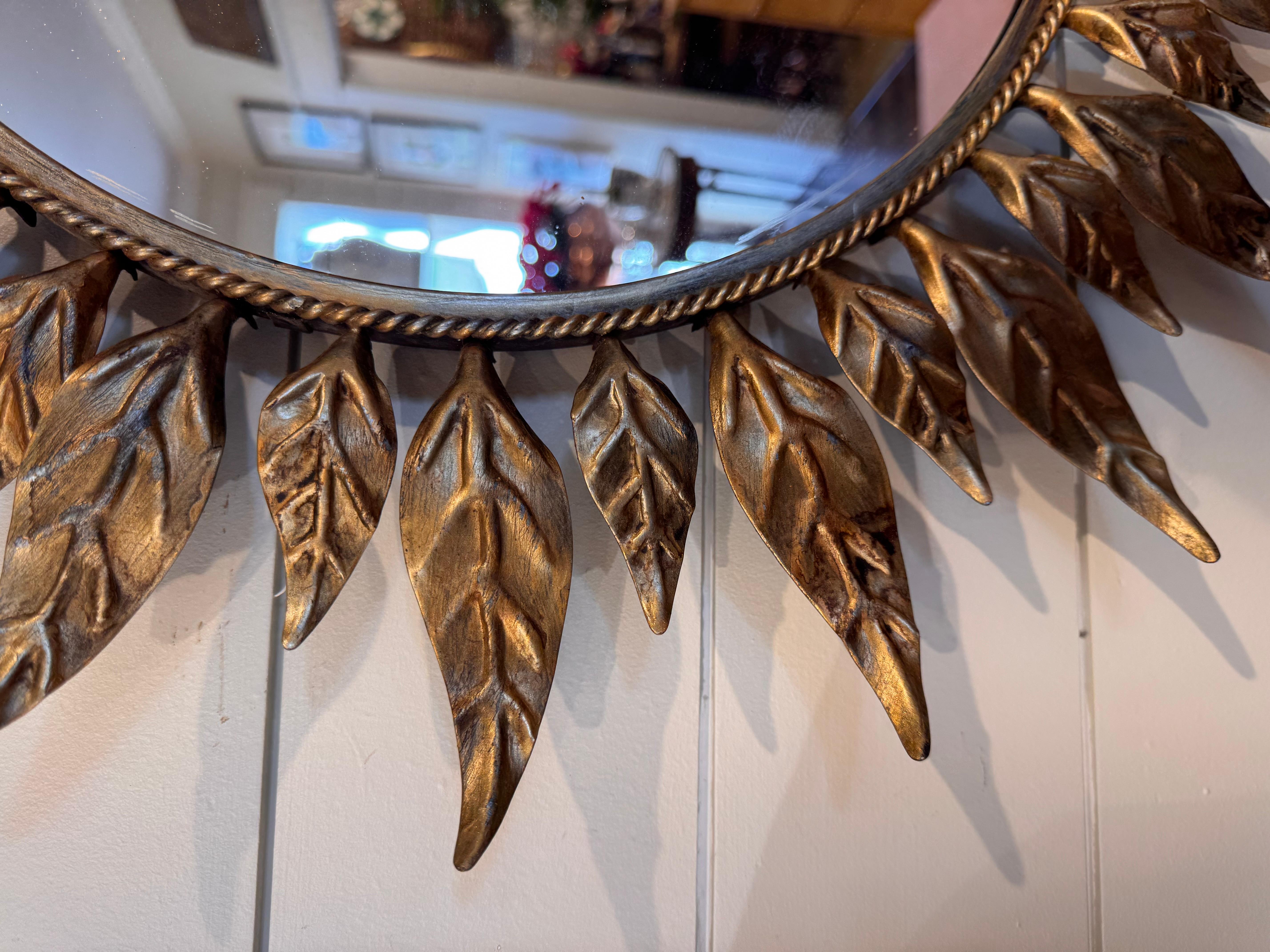 This is a beautiful vintage Sunburst mirror from Spain these mirrors have a great appearance, made from metal not resin or plastic. The wooden rays are hand cut and shaped gilded in gold with Beautiful detail on the edges. It is no wonder mirrors