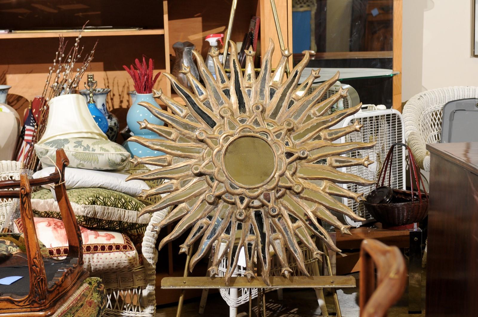 A beautiful sunburst mirror featuring a 7 inch diameter mirror in the center surrounded by mirror inserts in the frame. It could stand alone or be nice to use with an assortment of mirrors.