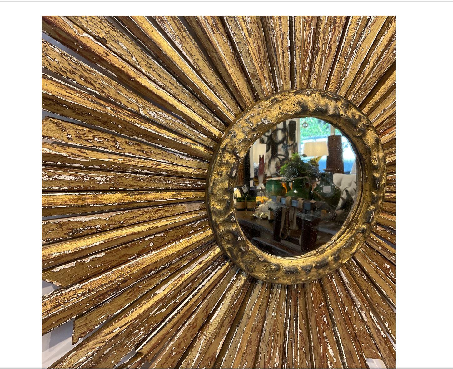 Beautiful Italian 19th century vintage sunburst mirror! This is a stunning piece with wooden rays that are hand carved and gilded in gold with beautiful detail on the edges. This would make a wonderful showstopping addition to any home!