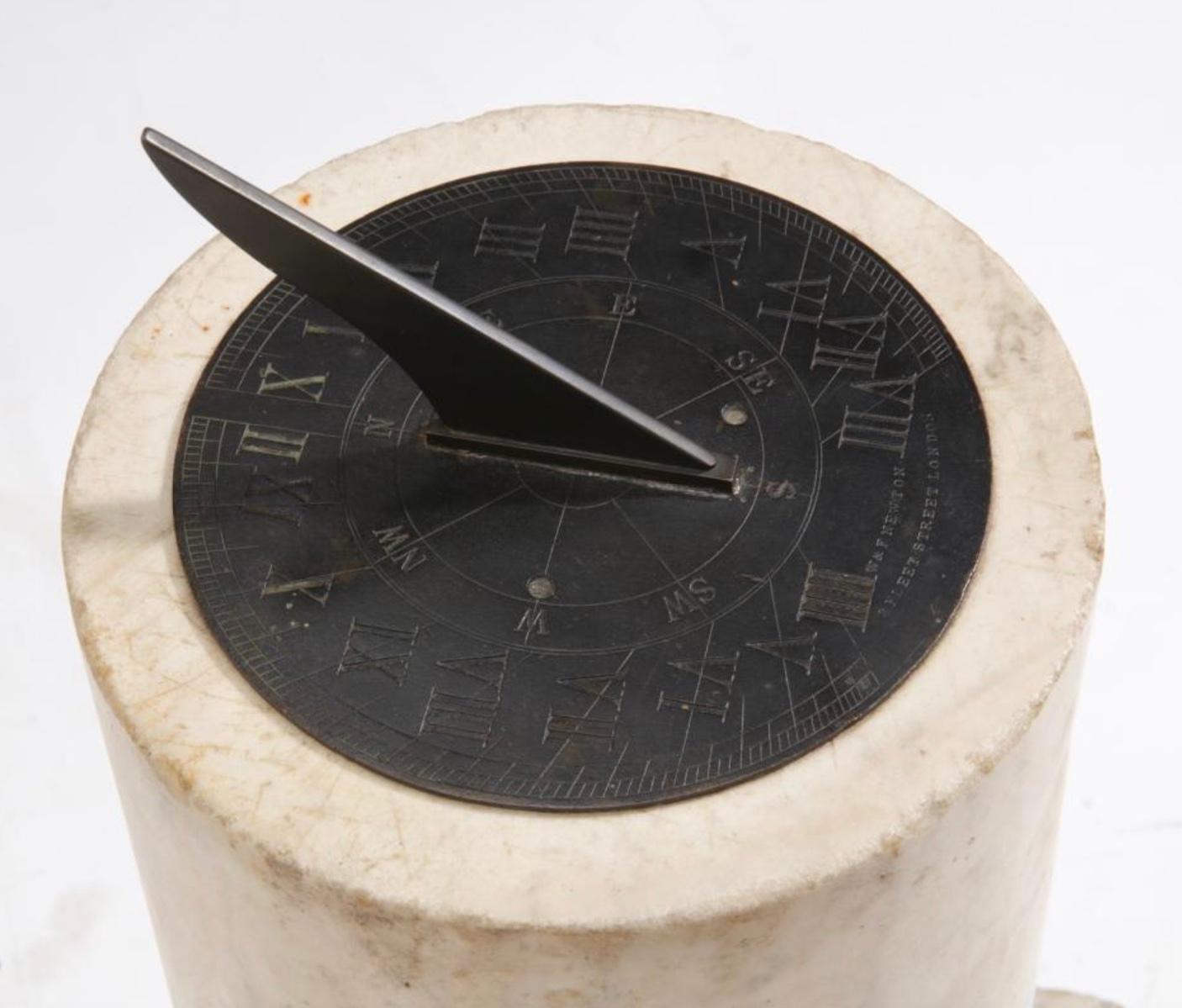 An English patinated bronze and variegated white marble sundial

The dial impressed W & F NEWTON / 3 FLEET STREET LONDON.