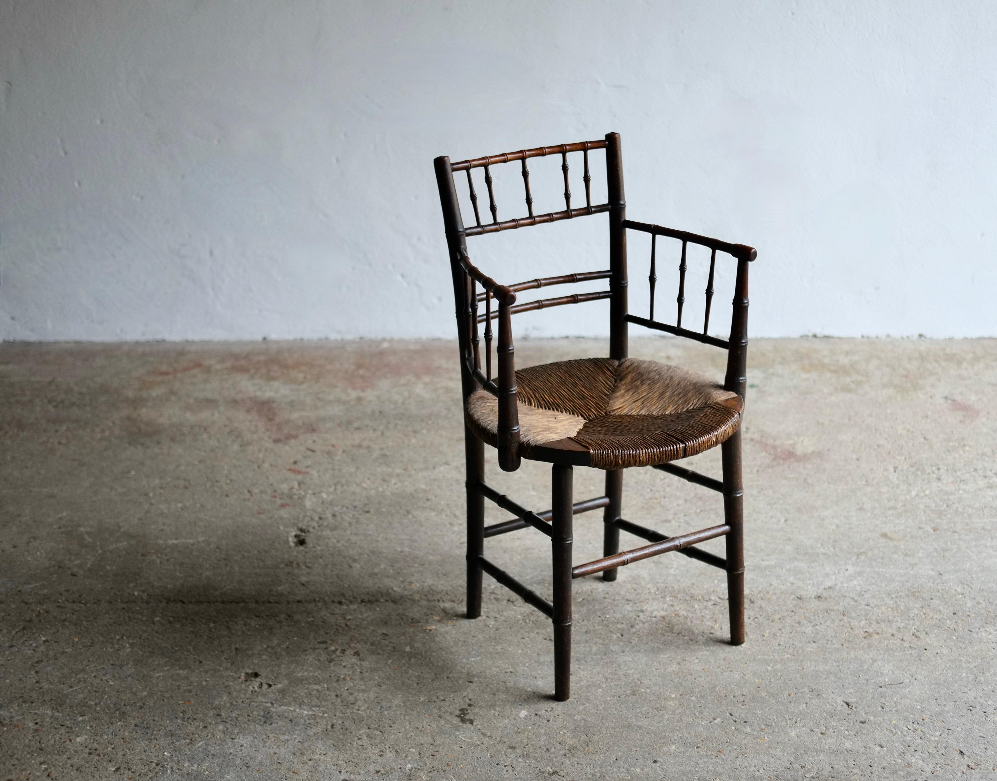 A 19th century stained beechwood Sussex chair attributed to Ford Madox Brown.

Carved bamboo effect design with circular rush seat. In good solid condition with no damage to the rush seat.

Pre Raphaelite artist and designer Ford Maddox Brown