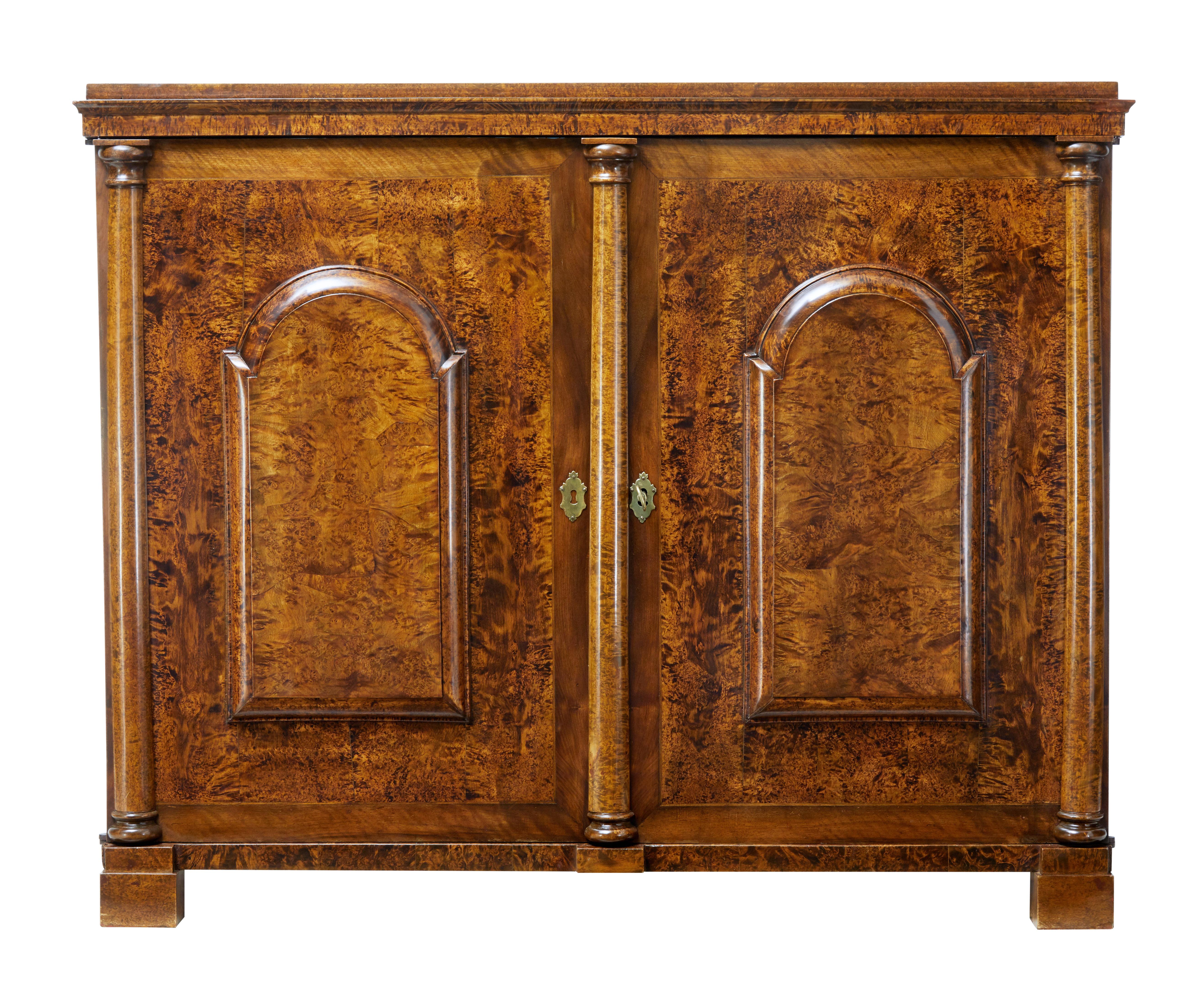 Stunning and rare cabinet in alder root, circa 1830.

Double door cabinet made from beautiful alder root veneers. Each door fitted with a block fronted panel, with central turned column flanked either side with columns on the corner. Sides with