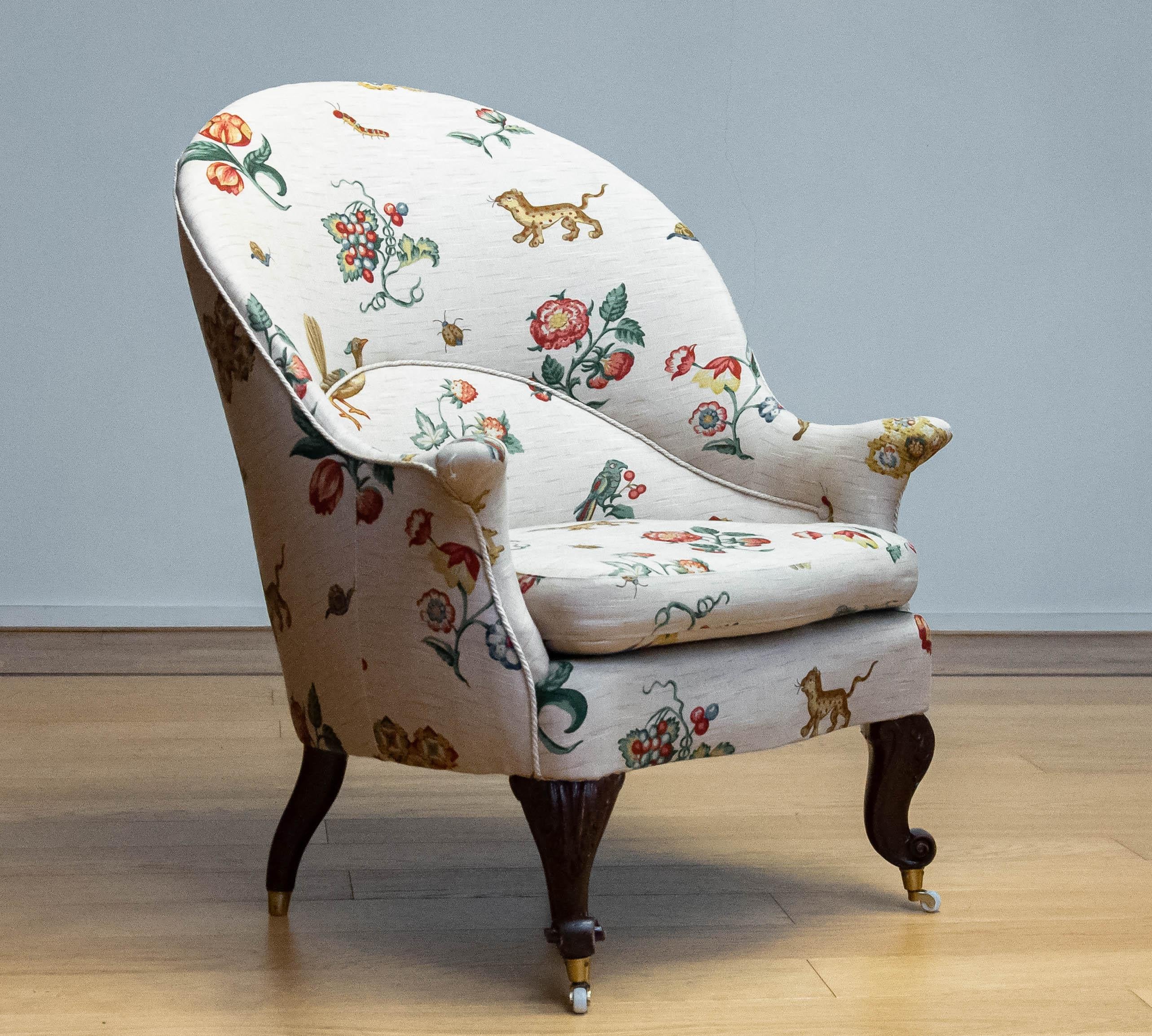 Beautiful armchair upholstered with linen flora and fauna / fantasy fabric. The large 'bow shape' backrest combined with the fine and slim 'horn shape' armrests resting on the rich carved cabriole legs makes this chair an absolute and elegant master