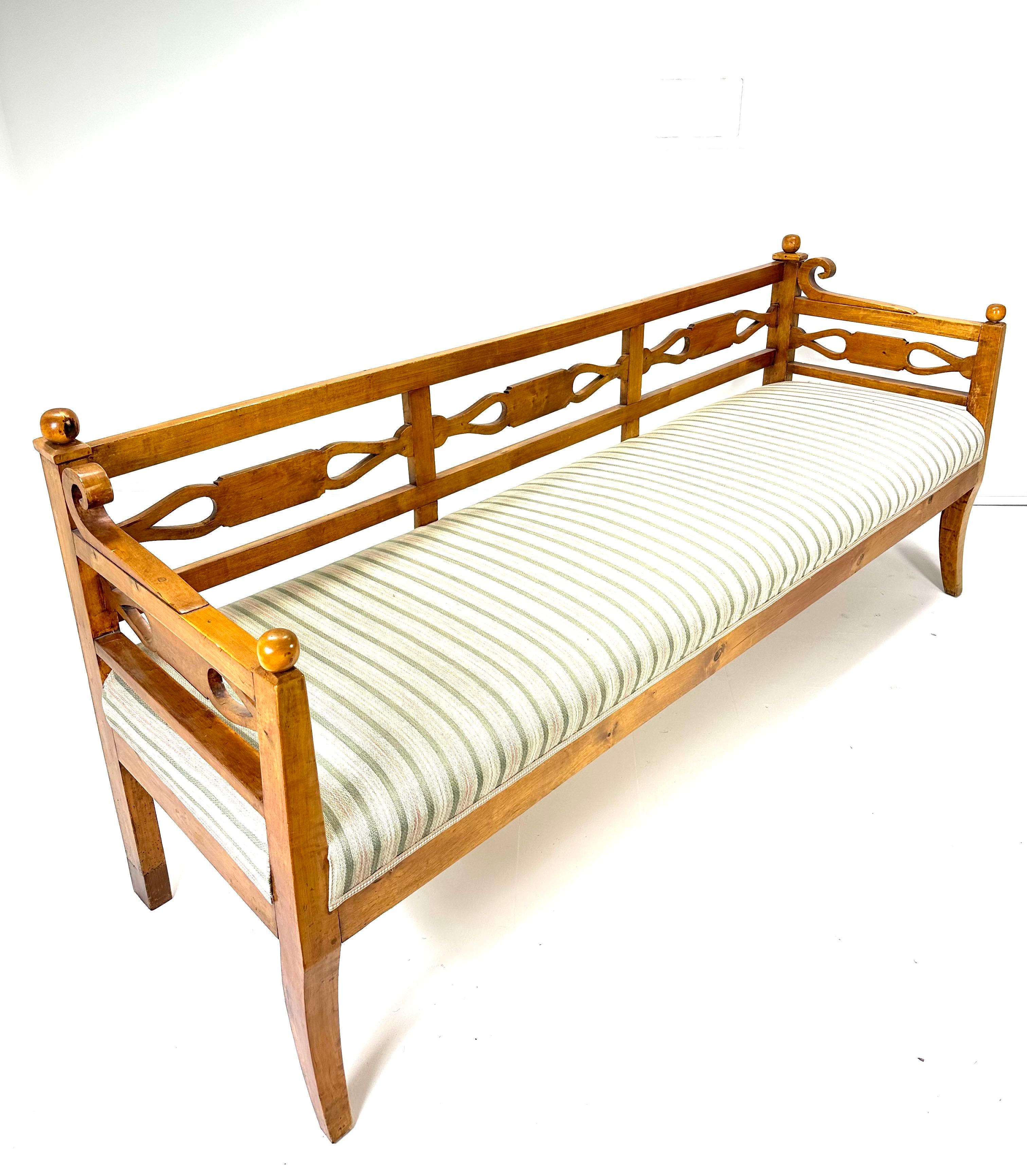 19th Century Swedish Bench. Carved open back and sides. Birch wood