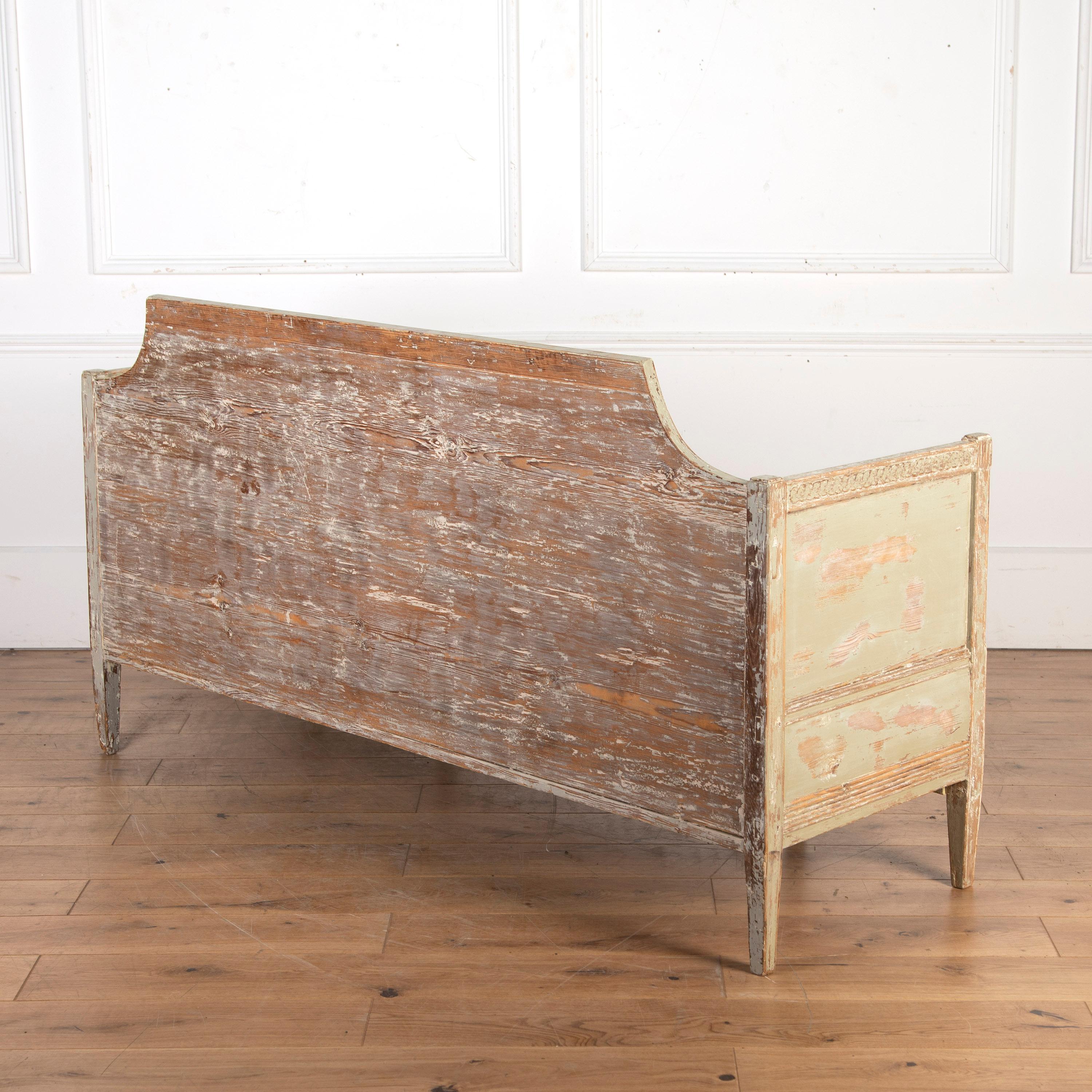 Early 19th Century Swedish painted sofa. 

This bench has been dry scraped back to its original sage green paint. The sofas seat has been stripped down to its calico interior and can be upholstered to your own specifications. Under the seat, there