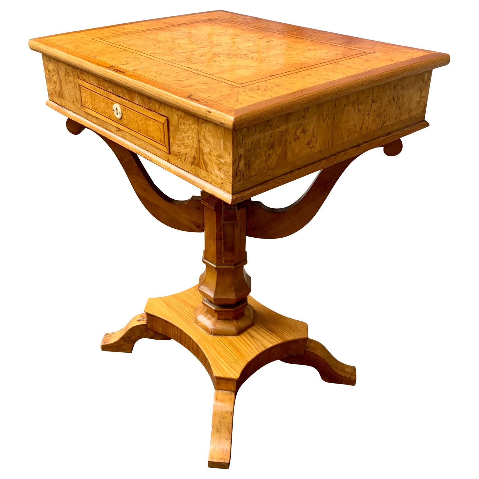 A Swedish sewing table in birch from the Biedermeier period, also called Karl Johan in Sweden. This style follows the name of the regent King of the period Karl the XIV Johan. This first part of the 19th Century working table for wealthy ladies, has
