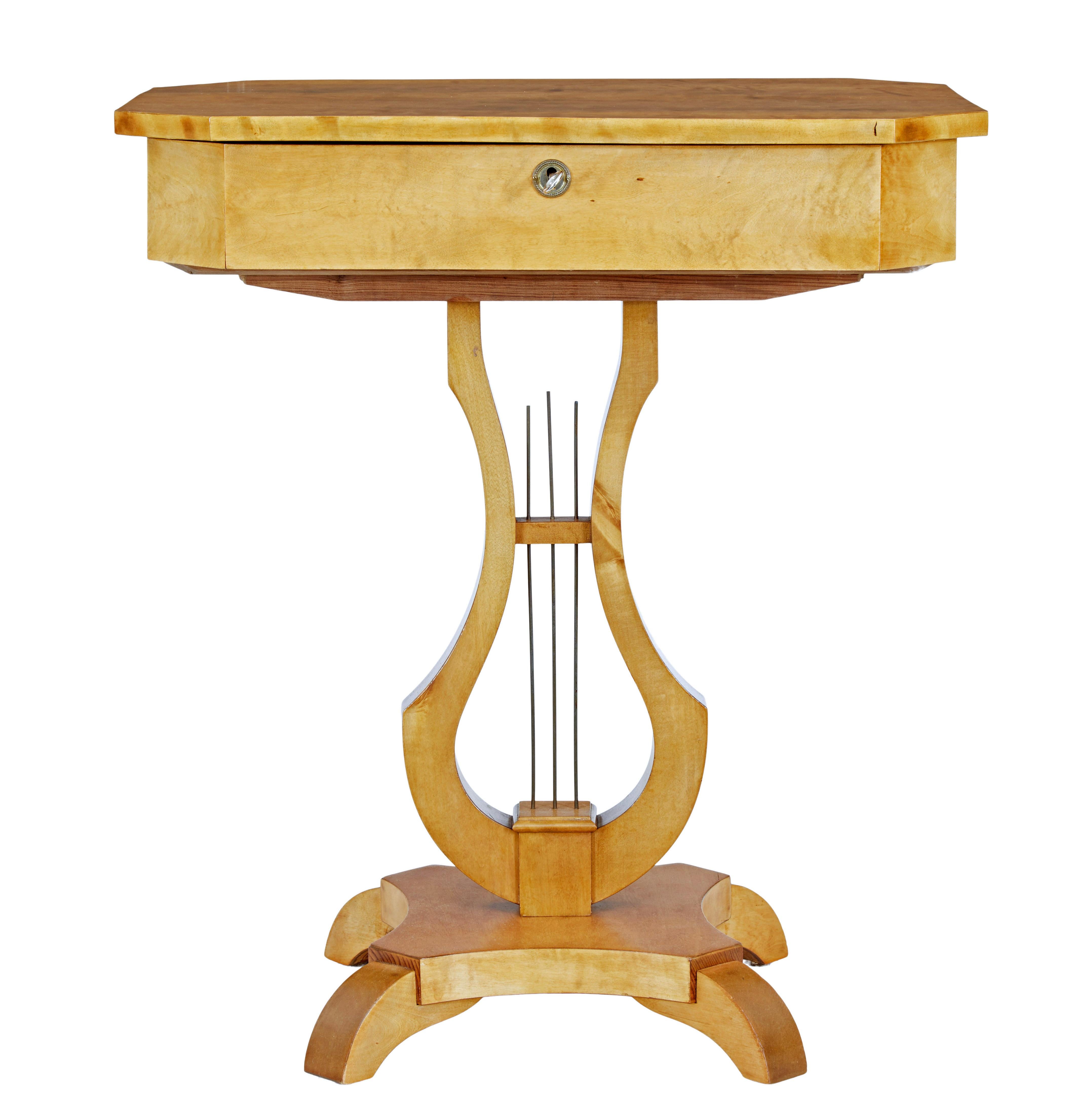 19th century Swedish birch lyre shaped occasional table circa 1890.

Rectangular top with canted corners.  Hinged lid opens to reveal a fitted interior of compartments arranged around a central pot.  Top is supported by a lyre shaped stand with