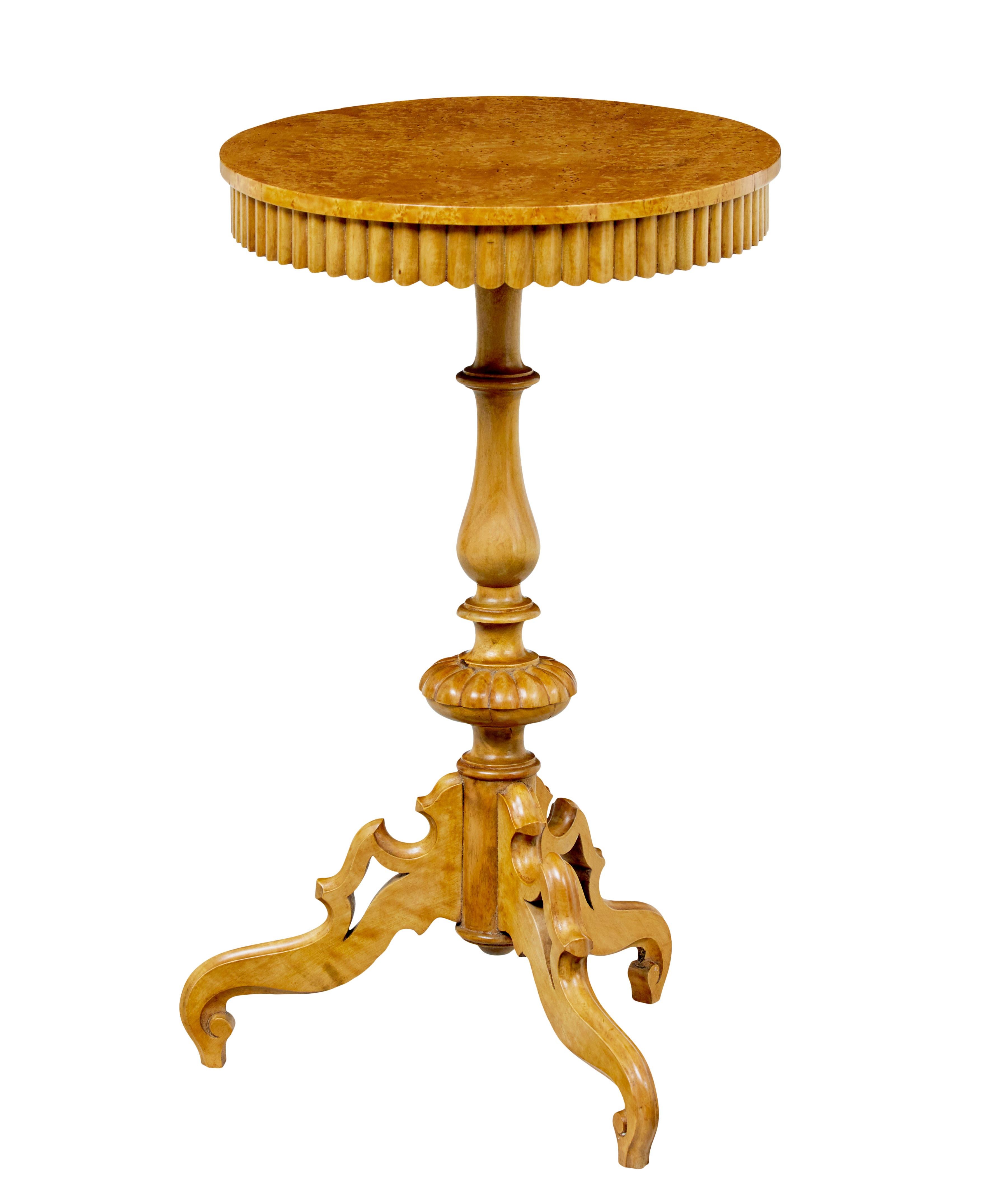 19th century Swedish birch oval occasional table circa 1890.

Burr birch oval top decorated with a scalloped frieze underneath the top edge. Top supported by a turned and carved stem and standing on scrolling pierced legs. Ideal size for multiple