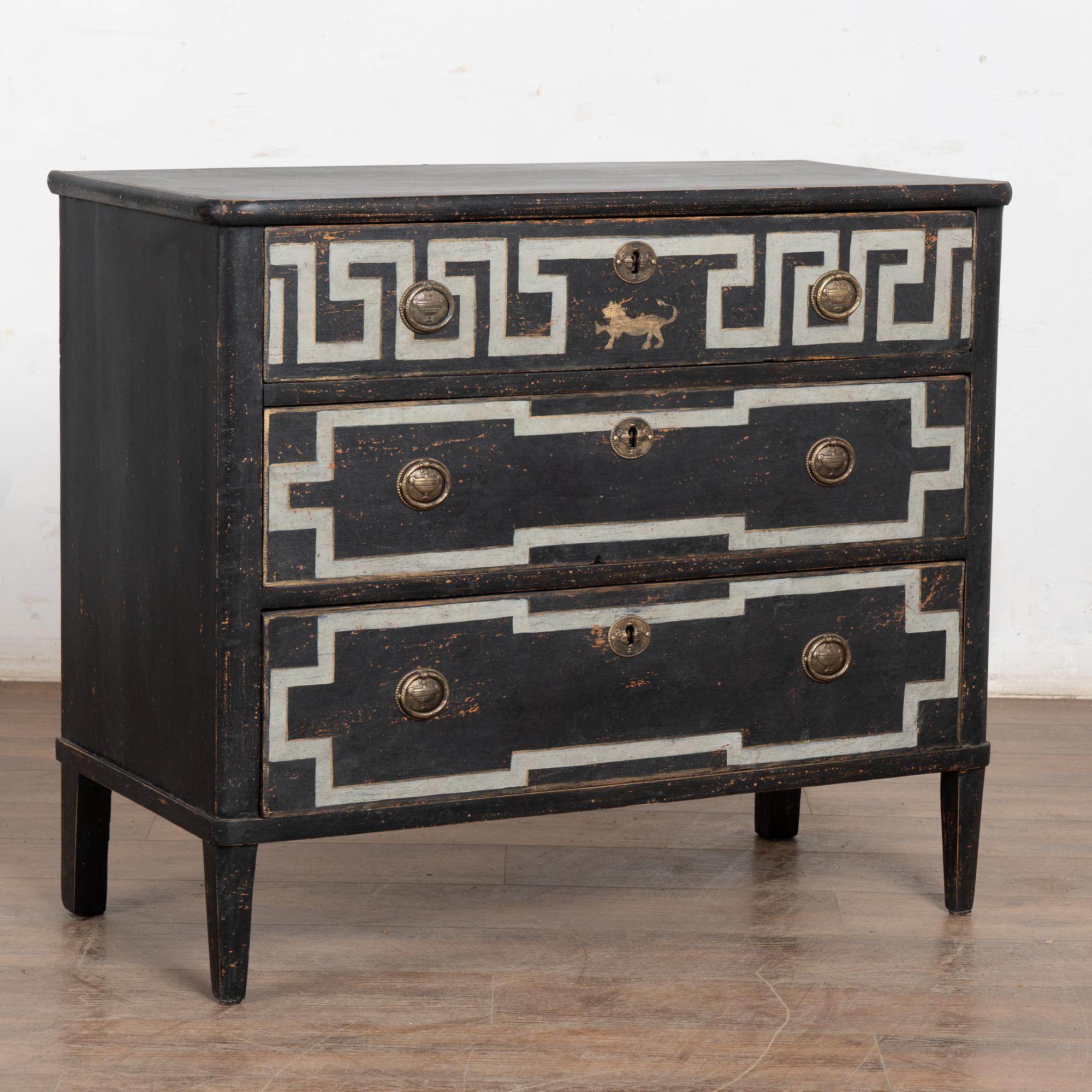 A decorative Gustavian style pine chest of drawers with dramatic painted 