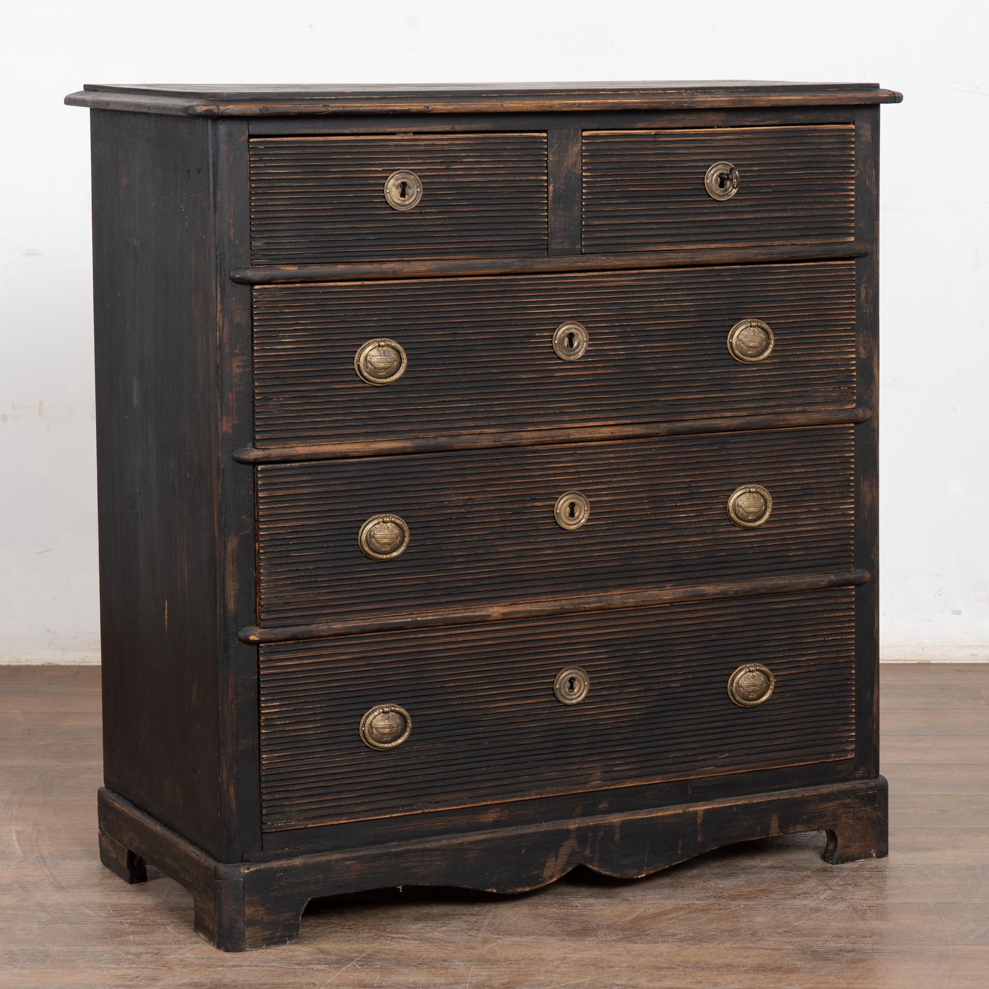 This large pine chest of drawers features two smaller drawers over three large drawers all with traditional Swedish fluted carving. 
A key is used to open the top two drawers, whether buyer wishes to utilize the old locks or simply use the key as a