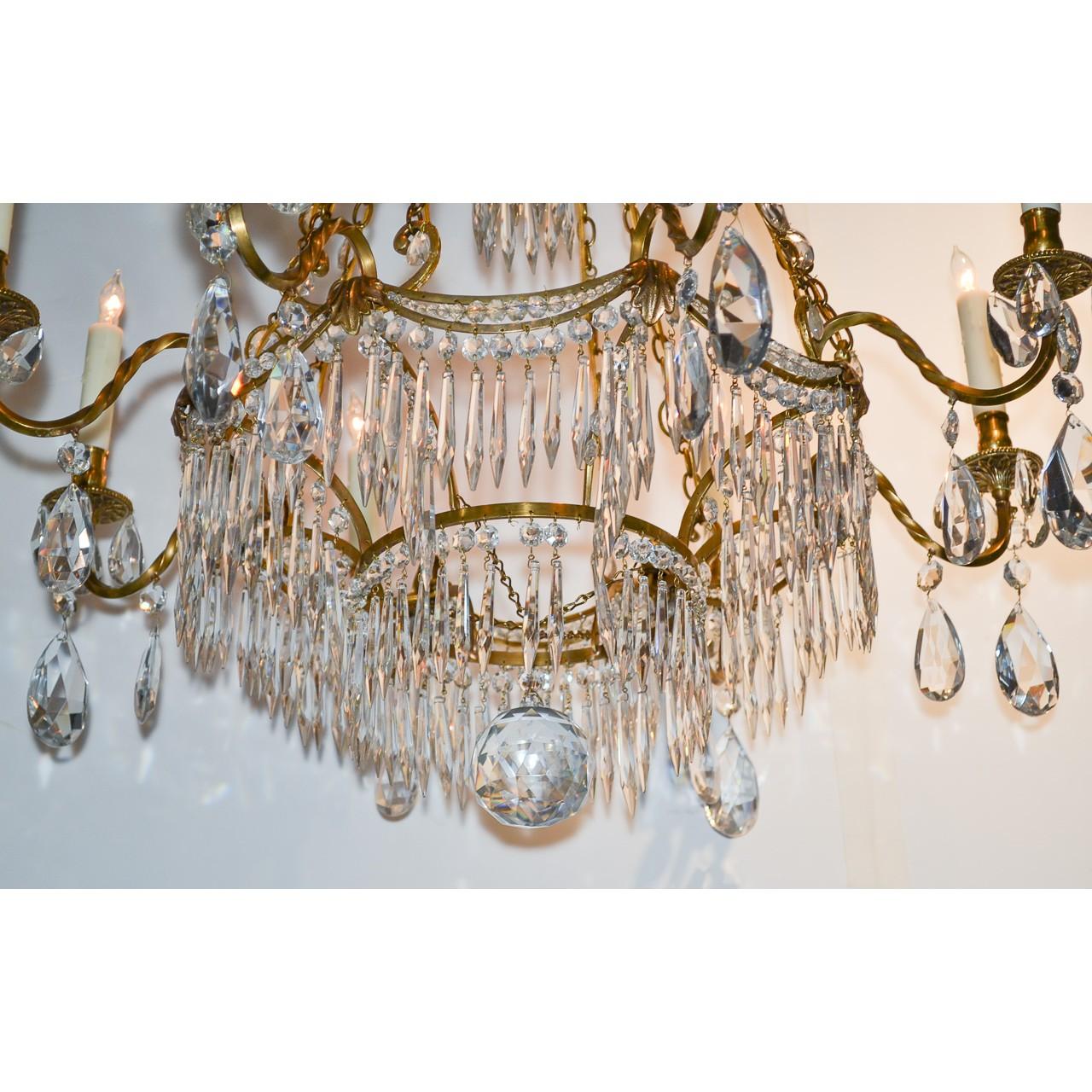 Superior quality 19th century Swedish bronze and crystal chandelier. The large crown with curved arms having dangling spear-shaped and bead crystal prisms holding bronze chains inset with faceted cabochons. The scrolling bronze arms mounted with six