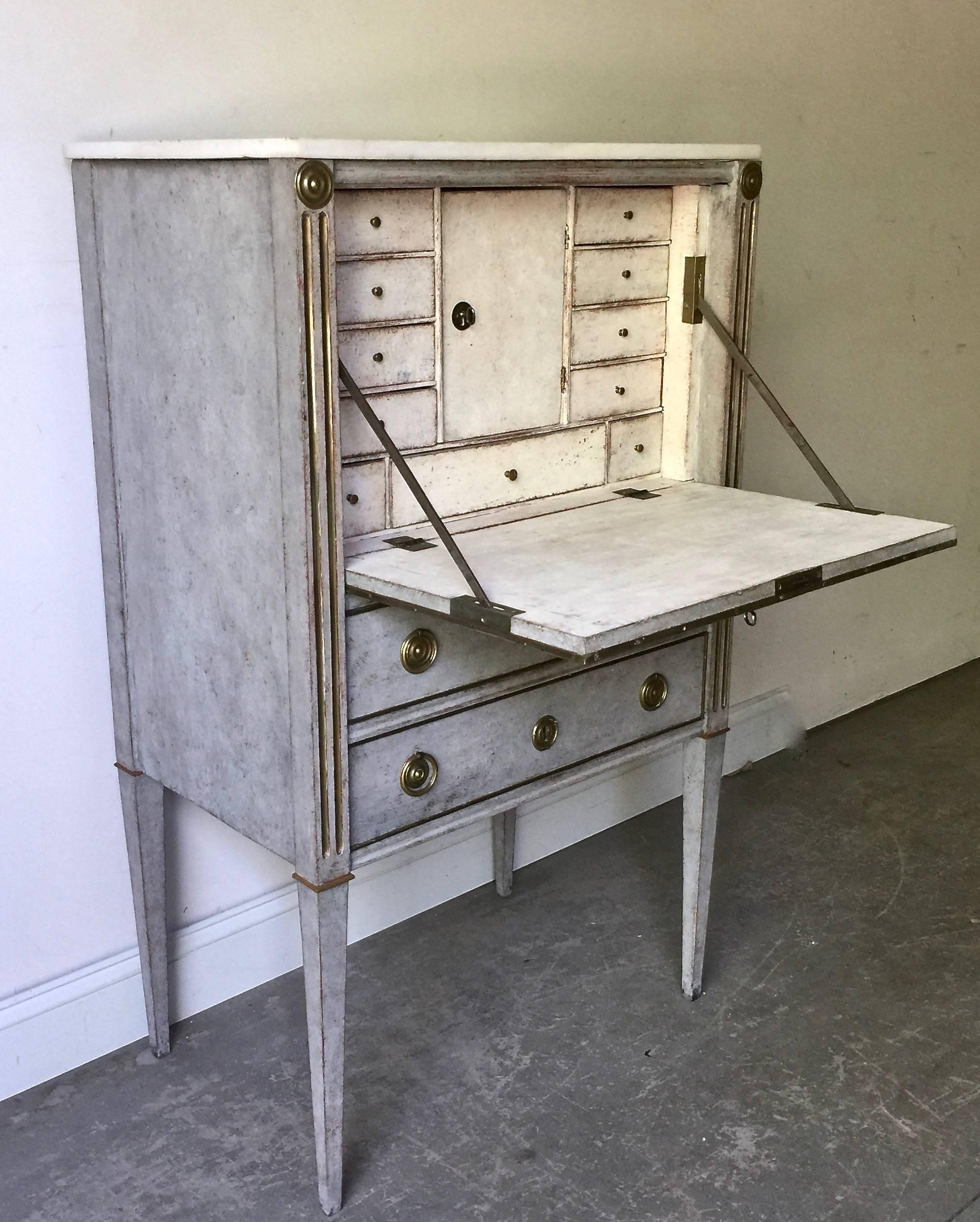 Charming small Swedish Gustavian ladies Bureau with marble top and drop-down desk surface with banks of small drawers and compartment on two standard drawers with long slender tapered legs. Very practical for any small places.
Sweden, circa