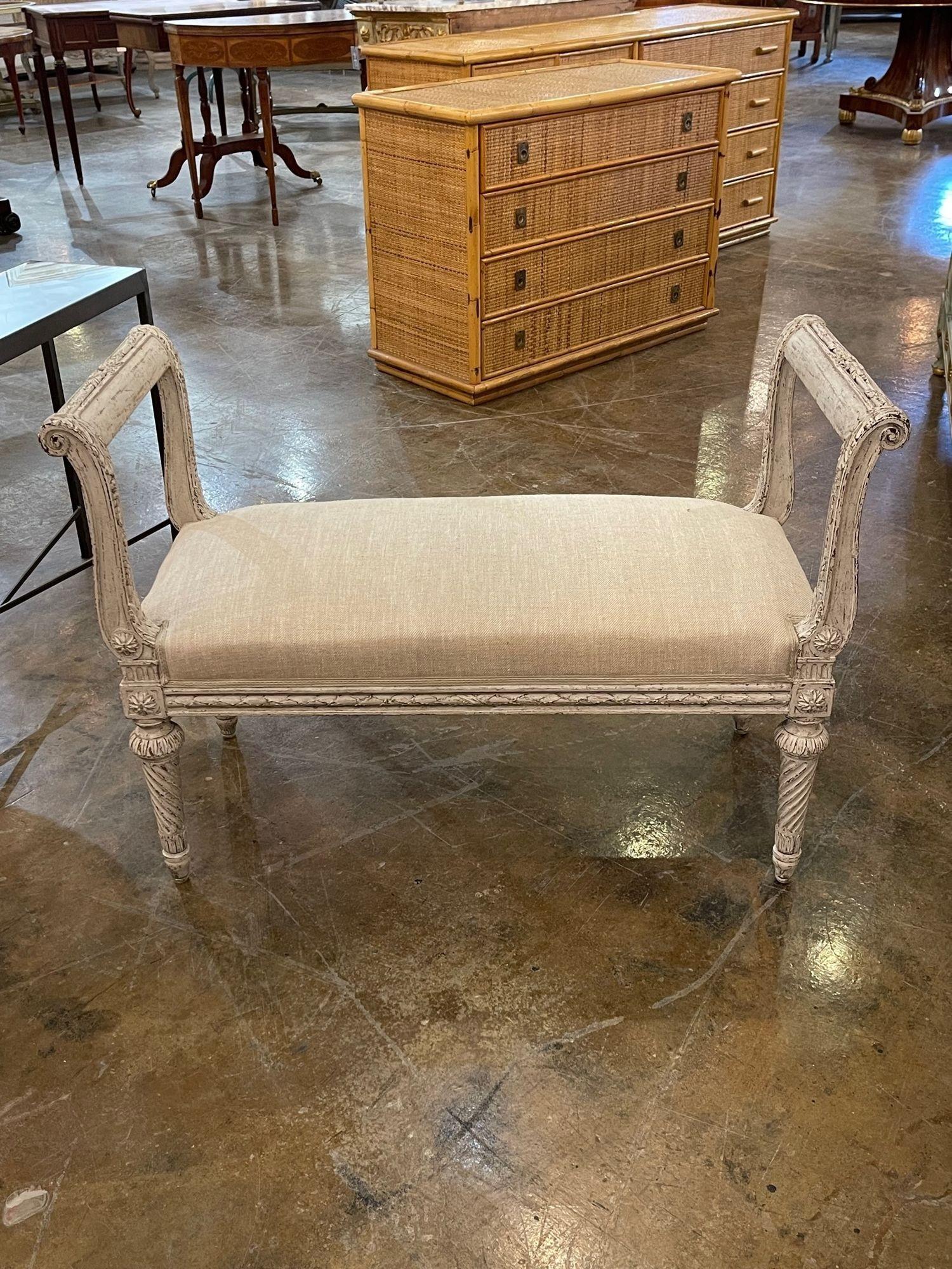 Lovely 19th century Swedish carved and painted bench. This piece has very nice carvings and is upholstered in a pretty tan colored fabric. A classic design for a fine home!