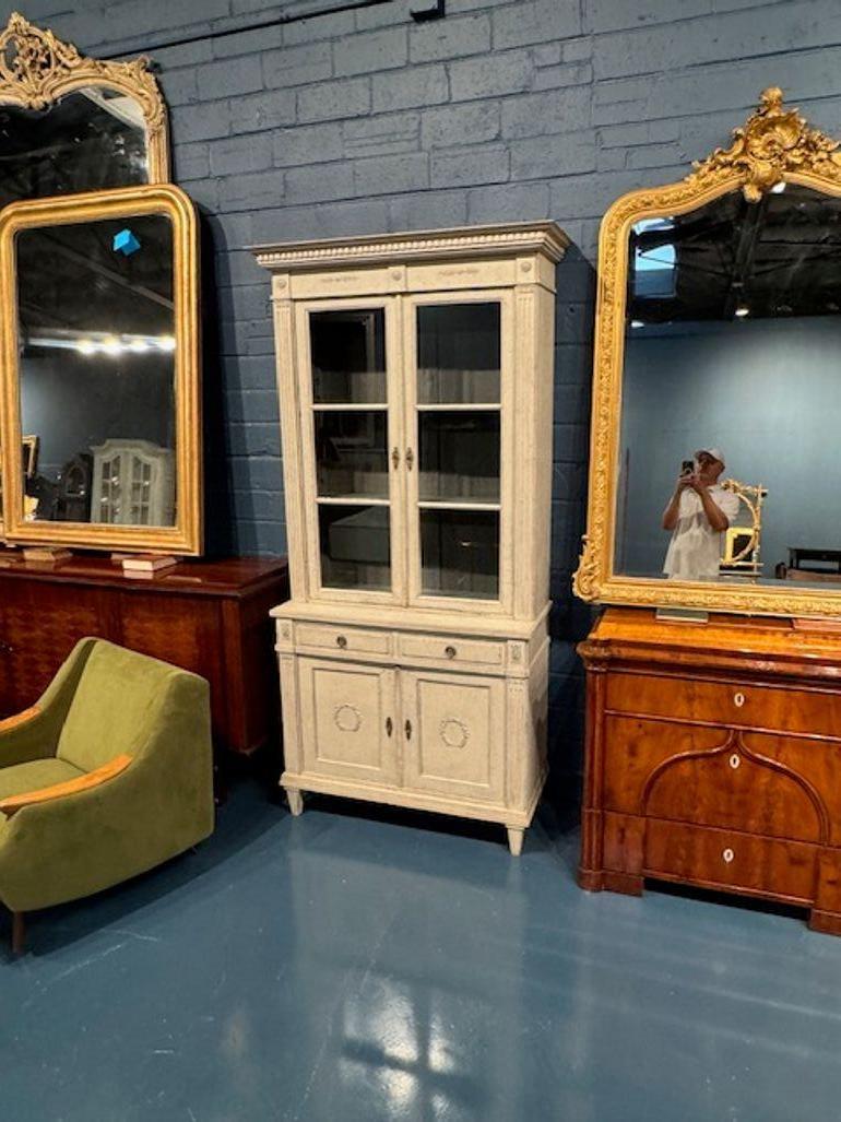 Introducing a lovely 19th century Swedish carved and painted Gustavian style cabinet. Crafted with care, this cabinet is a perfect addition to your collection of antique furniture. It offers ample storage space and can be used to display your