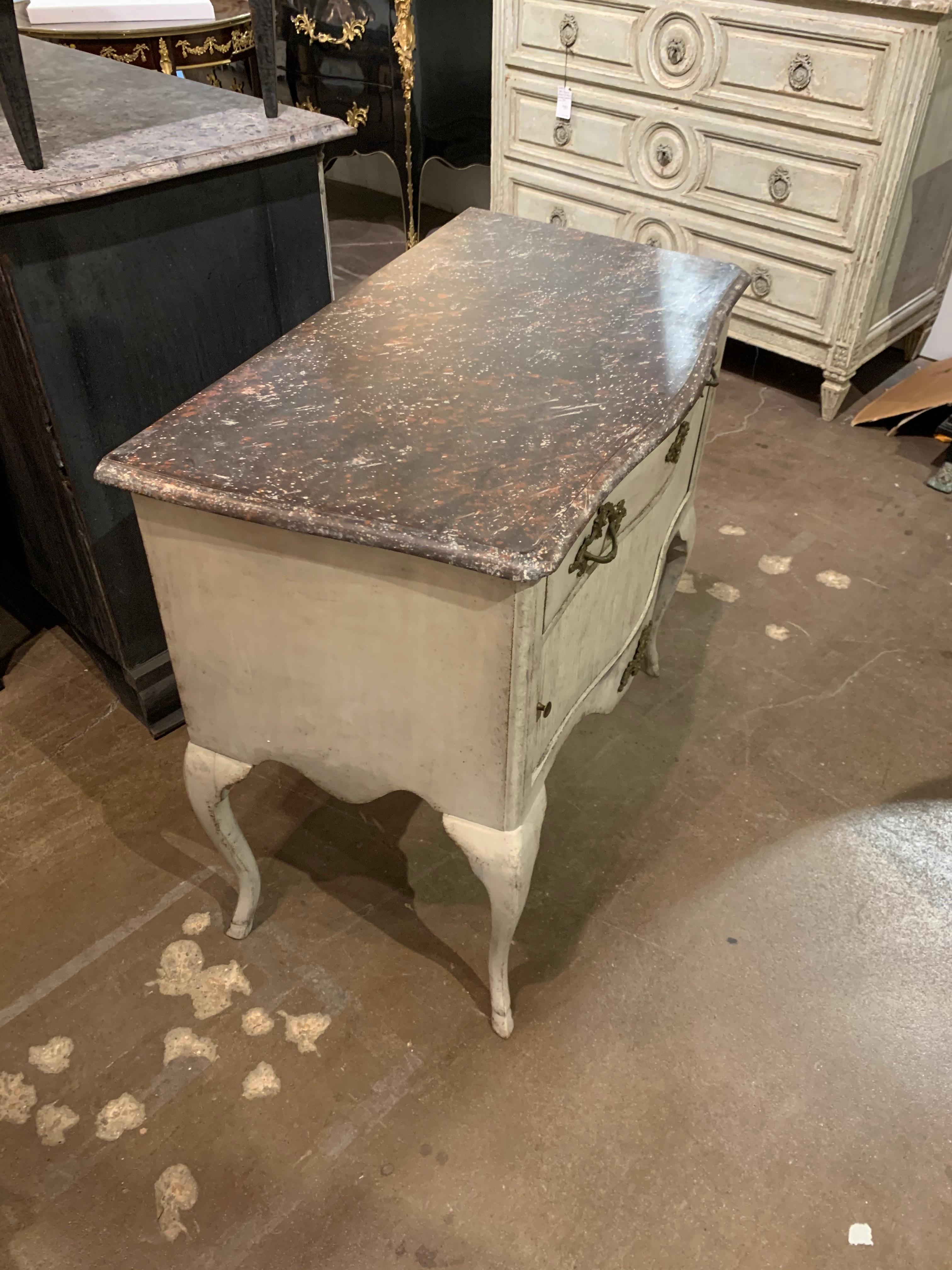 Beautiful 19th century carved and painted Swedish side table. Nice whitish grey patina on the base and the top is painted in a faux black marble. Lovely shape to this piece and there is a sliding door on the front. Very stylish!