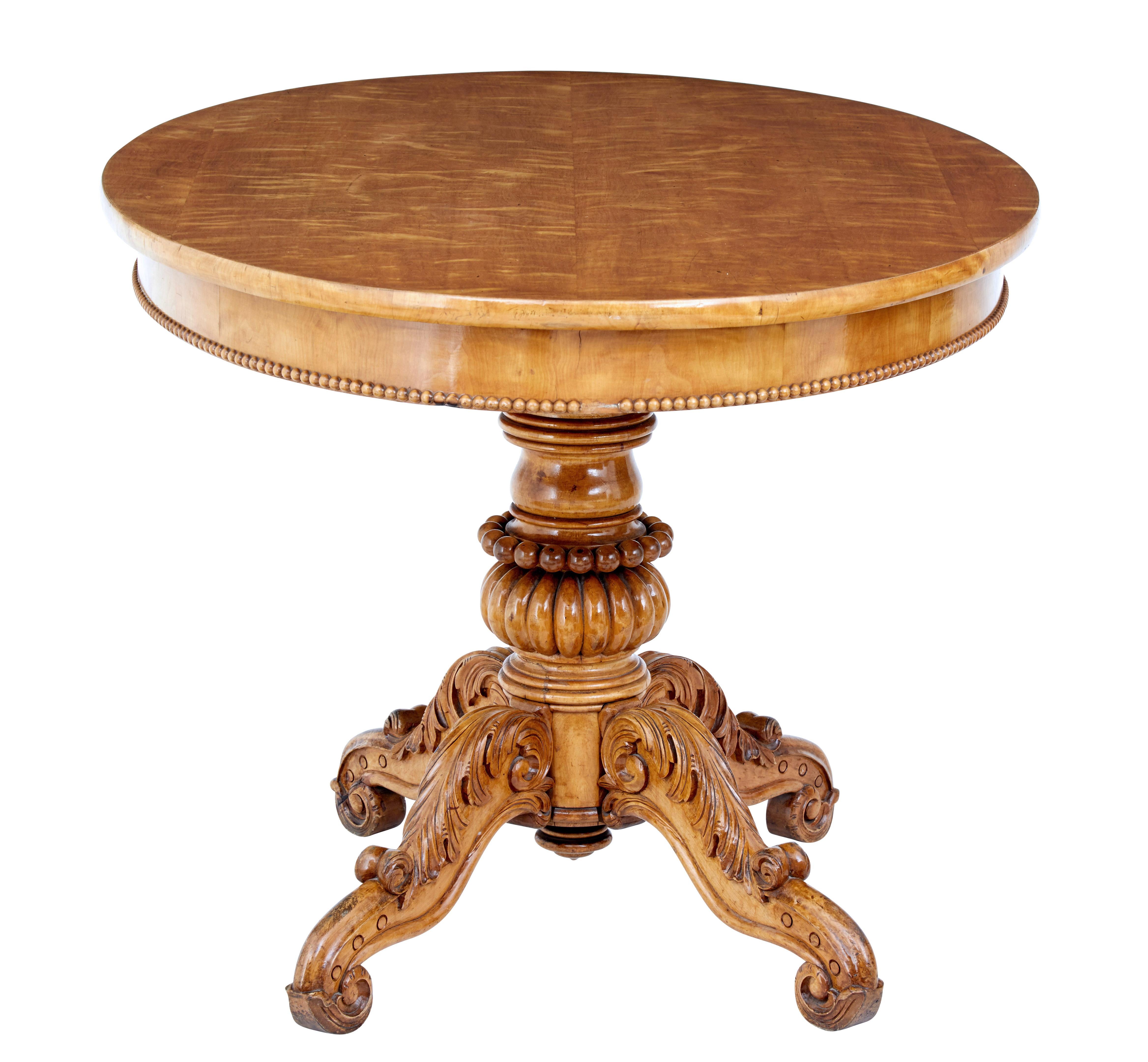 Decorative Swedish centre table of good proportions, circa 1870.

Simple large oval top with beaded edge to the frieze. Standing on a turned and carved stem with 4 profusely carved scrolling legs.

Rich golden color.

Light scratches to top