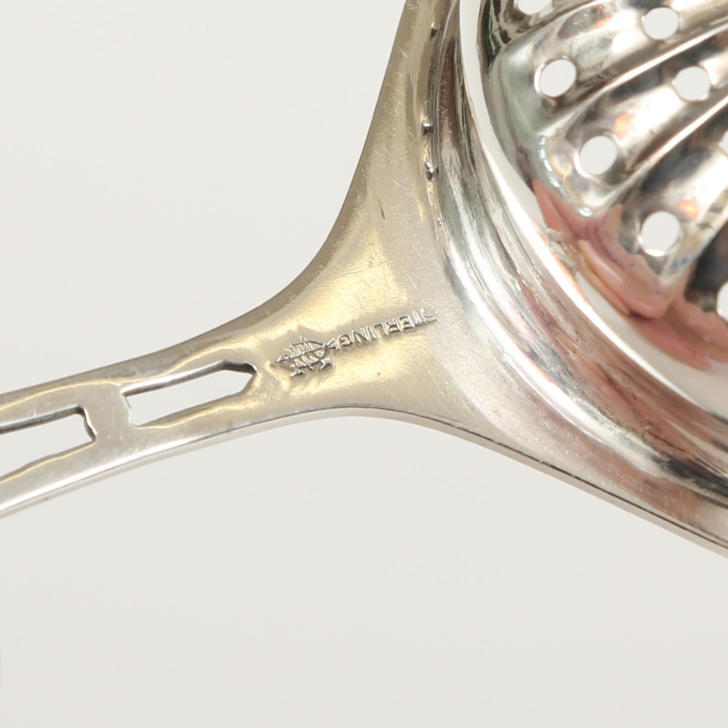 Sterling silver tea strainer by Webster Silver Company. The interesting feature here is that the handle is shaped like the back splat on a Chippendale chair. The Webster Silver Company was located in North Attleboro, Massachusetts and founded by