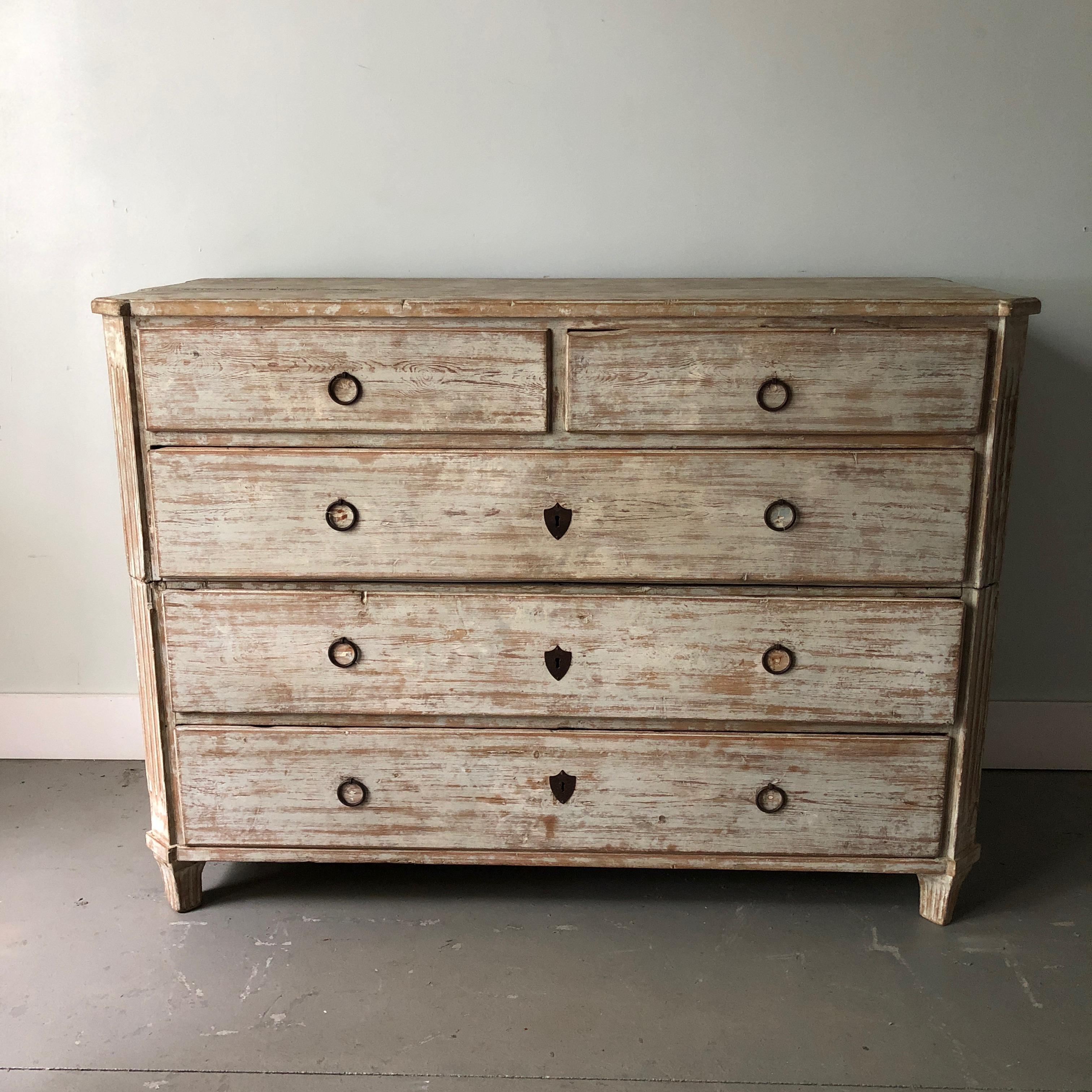 A large 19th century Swedish two part chest of drawers with three large drawers below two smaller drawers,
Shaped top, sides with original oversized handles on each side for convenient travels, canted and reeded corner posts on tapering square