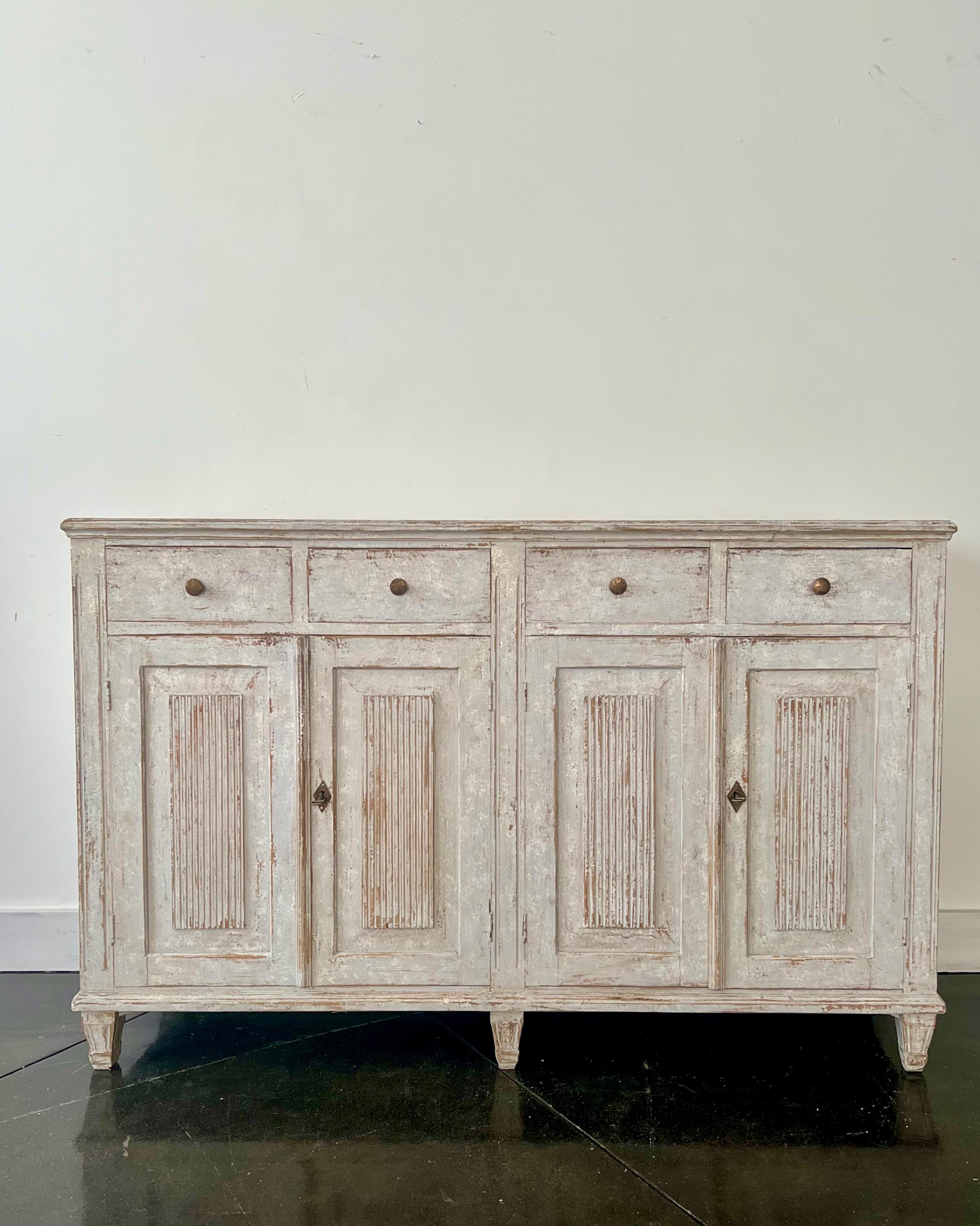 A rare four door Swedish 19th century sideboard in the classic Gustavian Style with carved reeded panel doors and bank of four drawers.
Stockholm, Sweden ca 1850-60