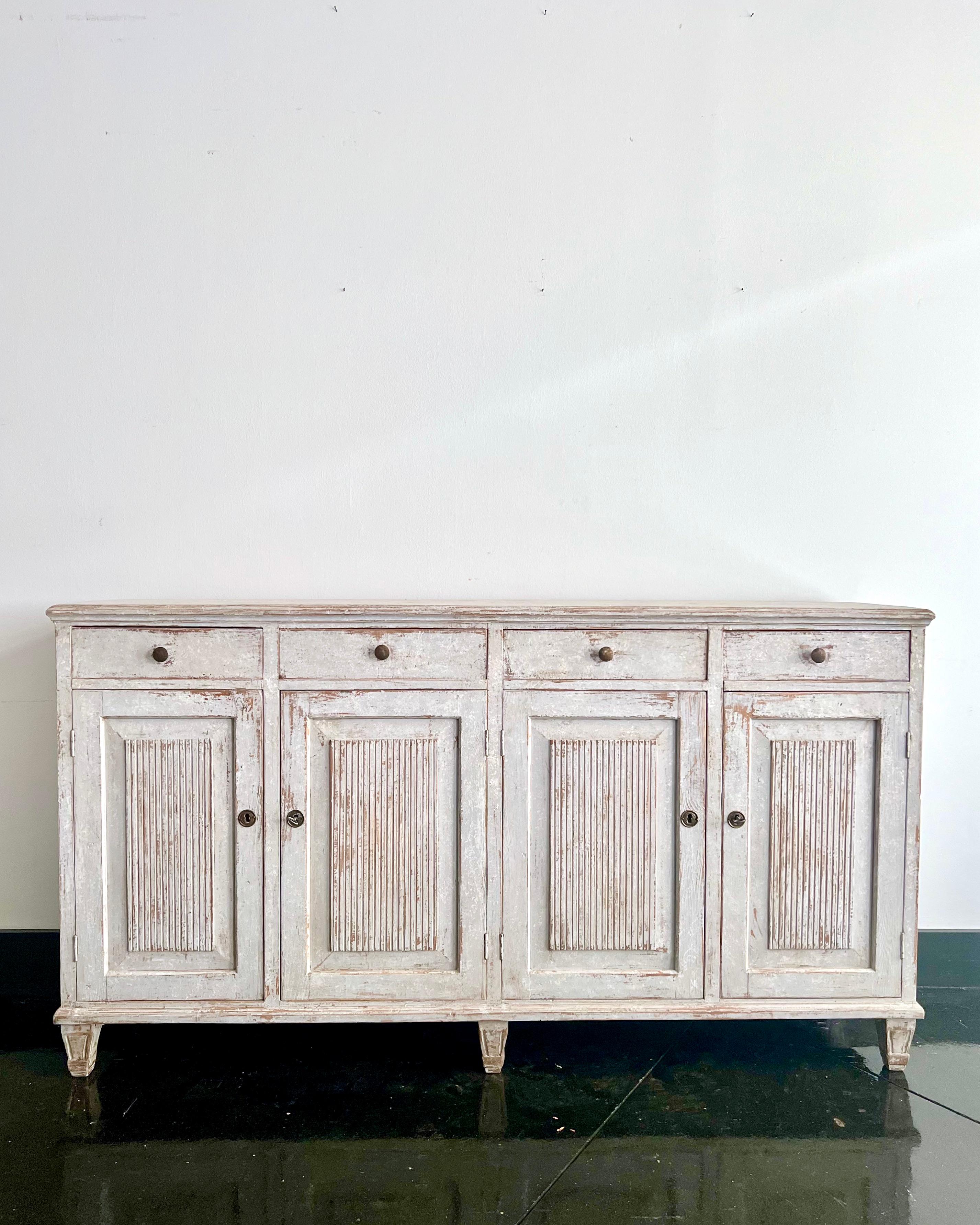 A rare four door Swedish 19th century sideboard in the classic Gustavian Style with carved reeded panel doors and bank of four drawers.
Stockholm, Sweden ca 1850