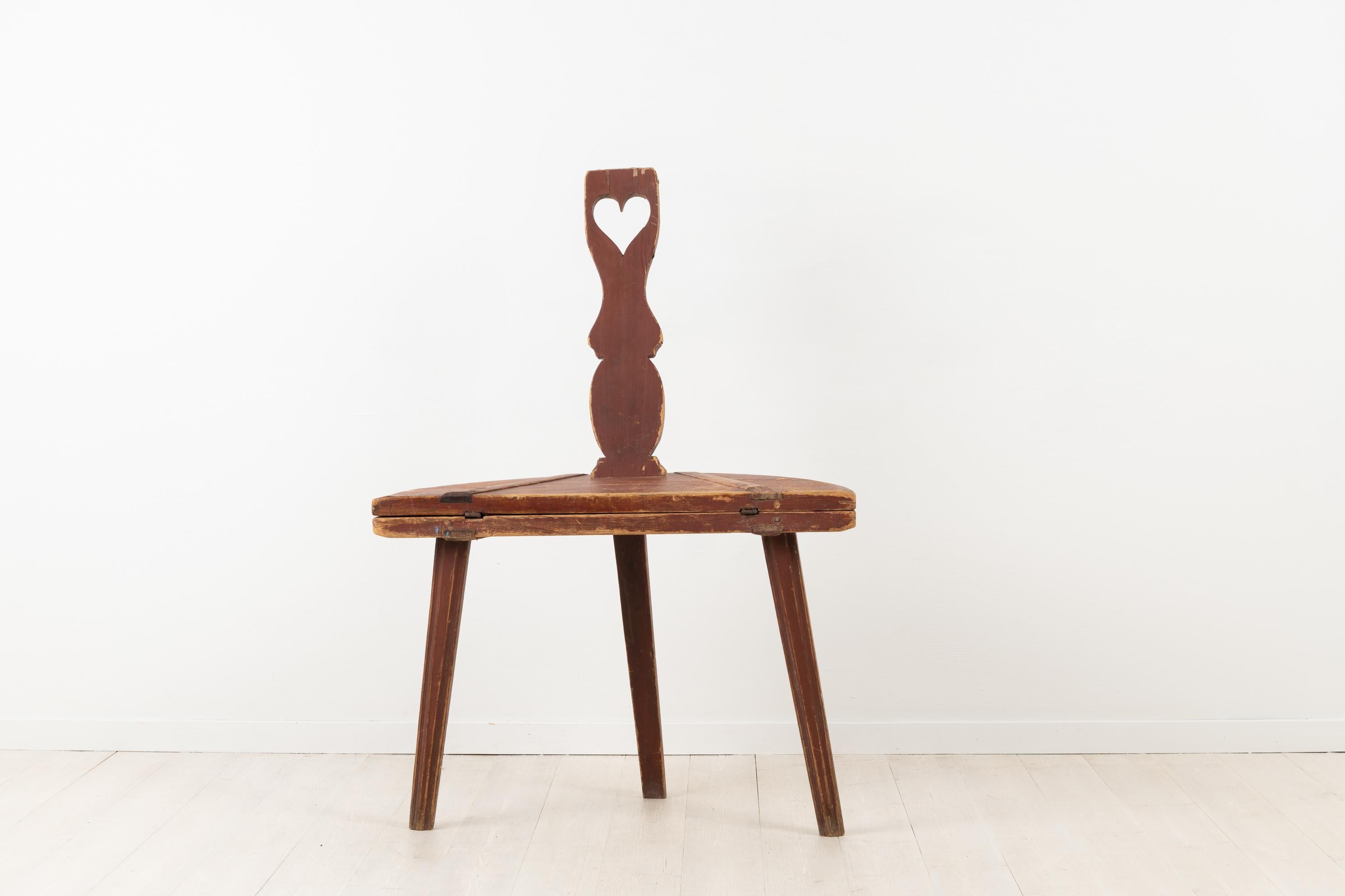 Folk Art combination furniture table and chair. Combination furniture are great for small spaces and this works well as a coffee table or side table. Made early 1800s, circa 1820-1840. Decorated with a heart. Made in pine with original distressed