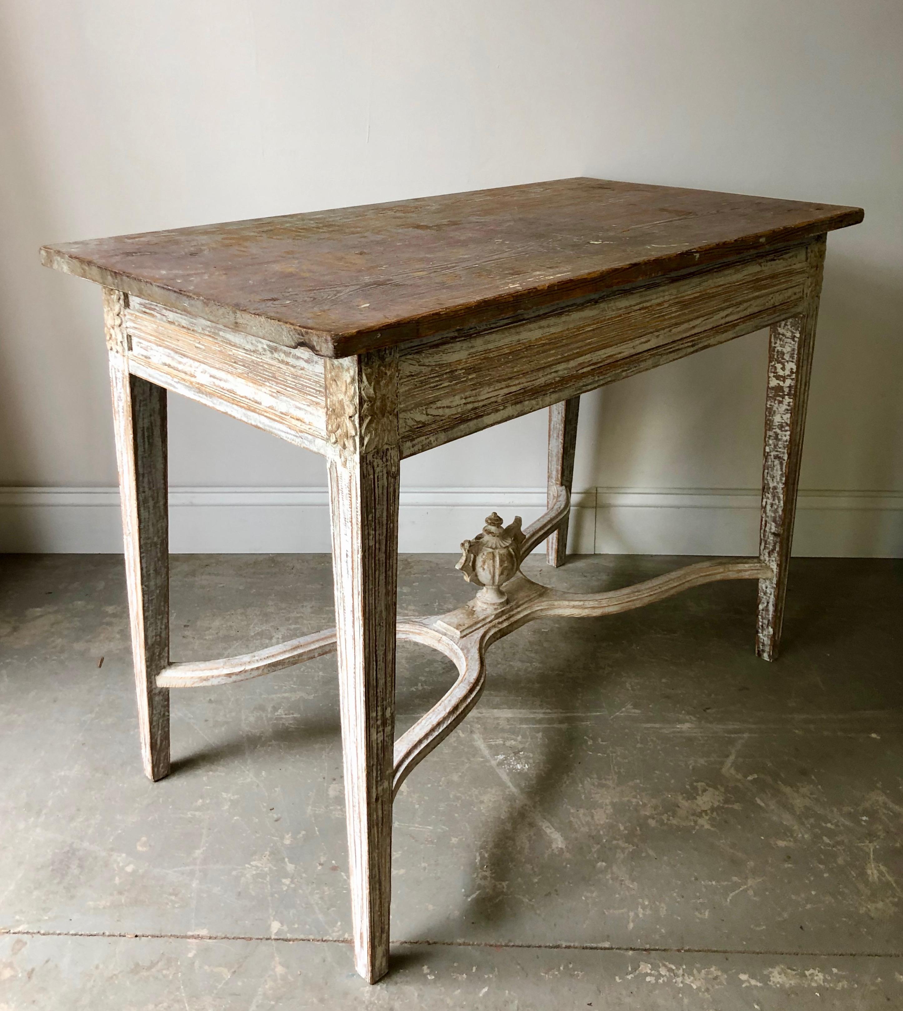 Swedish Gustavian style freestanding table with carved apron, tapering carved legs and saltire stretcher with grand central medallion in worn patina with darker wooden top.
Sweden, circa 1860.
Here are few examples surprising pieces and objects,