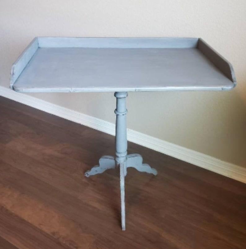 Pale, elegant simplicity and classic design, is how we would describe this large, subtly beautiful, hand carved and painted pine antique tray style table. 

Handcrafted in Sweden in the late 1800s, decorated in a muted gray-blue paint color,