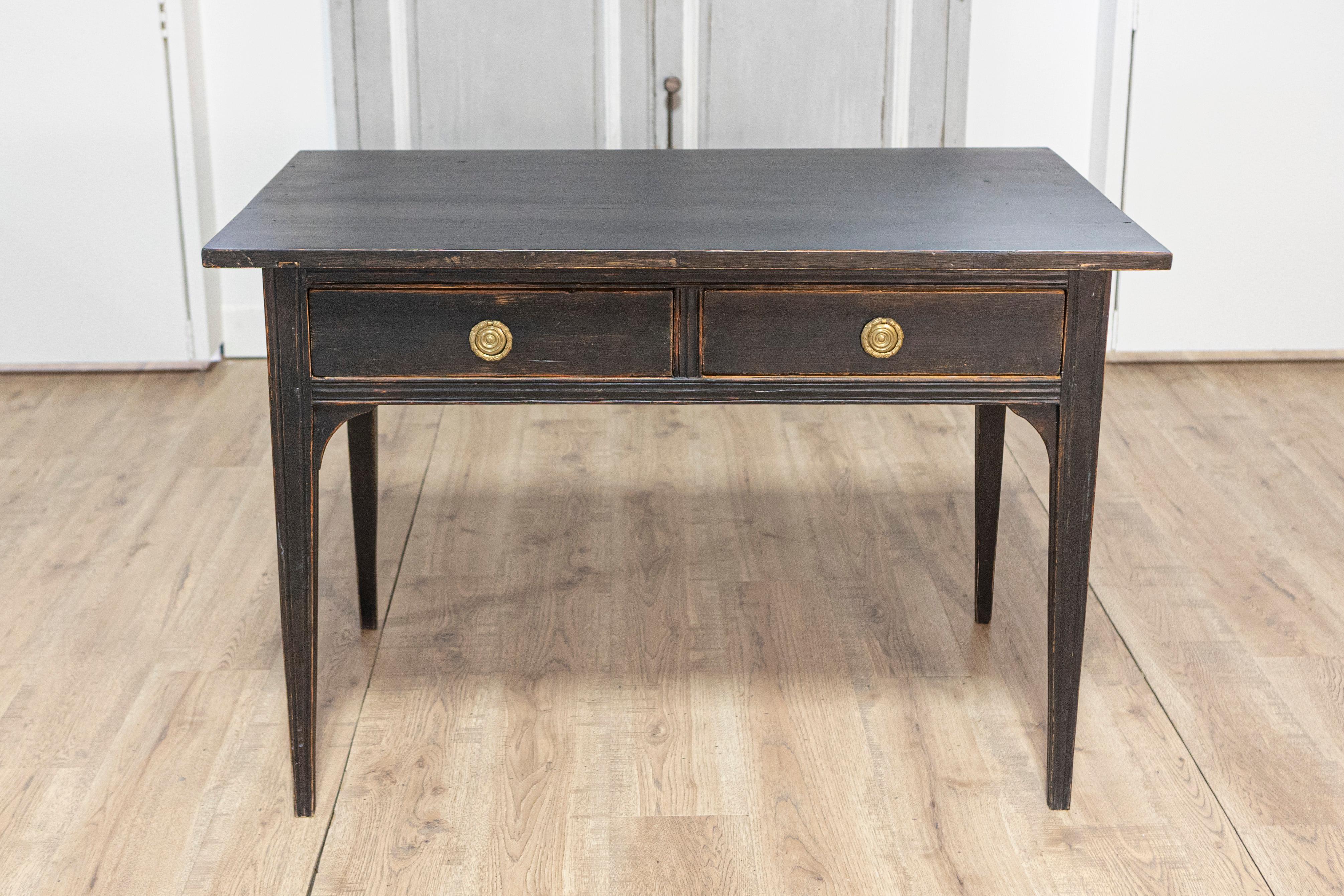 This refined 19th-century Swedish desk, circa 1840, is a stunning example of Scandinavian craftsmanship and neoclassical design. Crafted from solid pine wood, the desk features clean, elegant lines with a black hand-painted finish, lightly