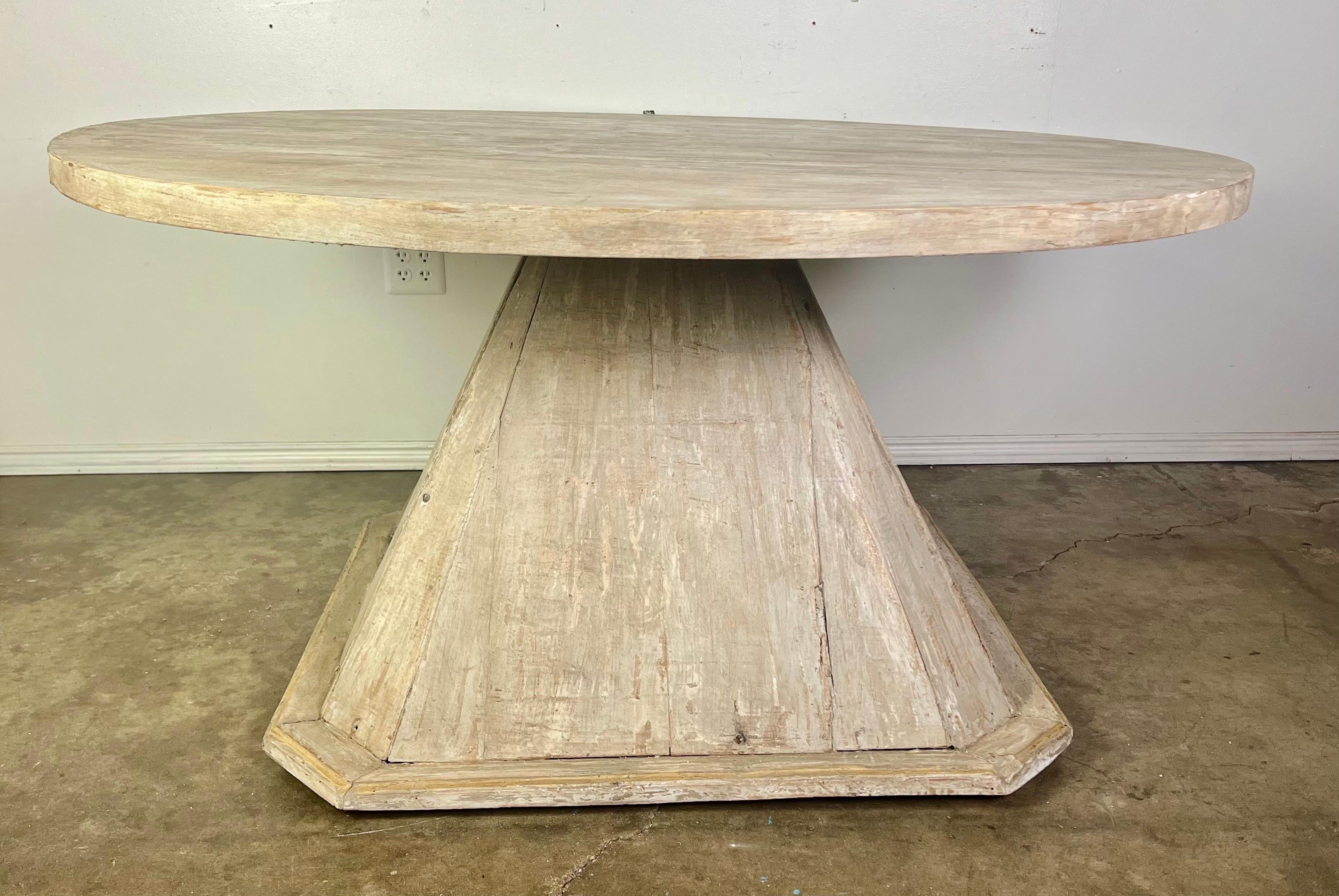 A 19th century Swedish dining table with a pyramid shaped base and a round, beautifully bleached wood top, featuring a light Gustavian style design.  It would undoubtedly bring a touch of Swedish elegance to any dining area.