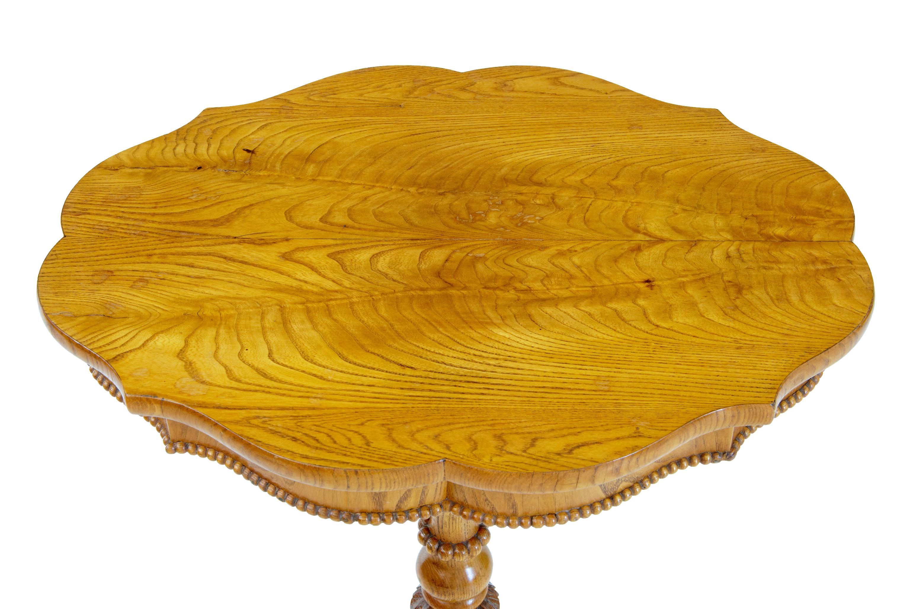 19th century Swedish elm shaped occasional table, circa 1870.

Good quality shaped top occasional table. Top veneered in matched elm and detailed with beaded edge below the frieze. Standing on a turned a carved stem, with 3 carved scrolled