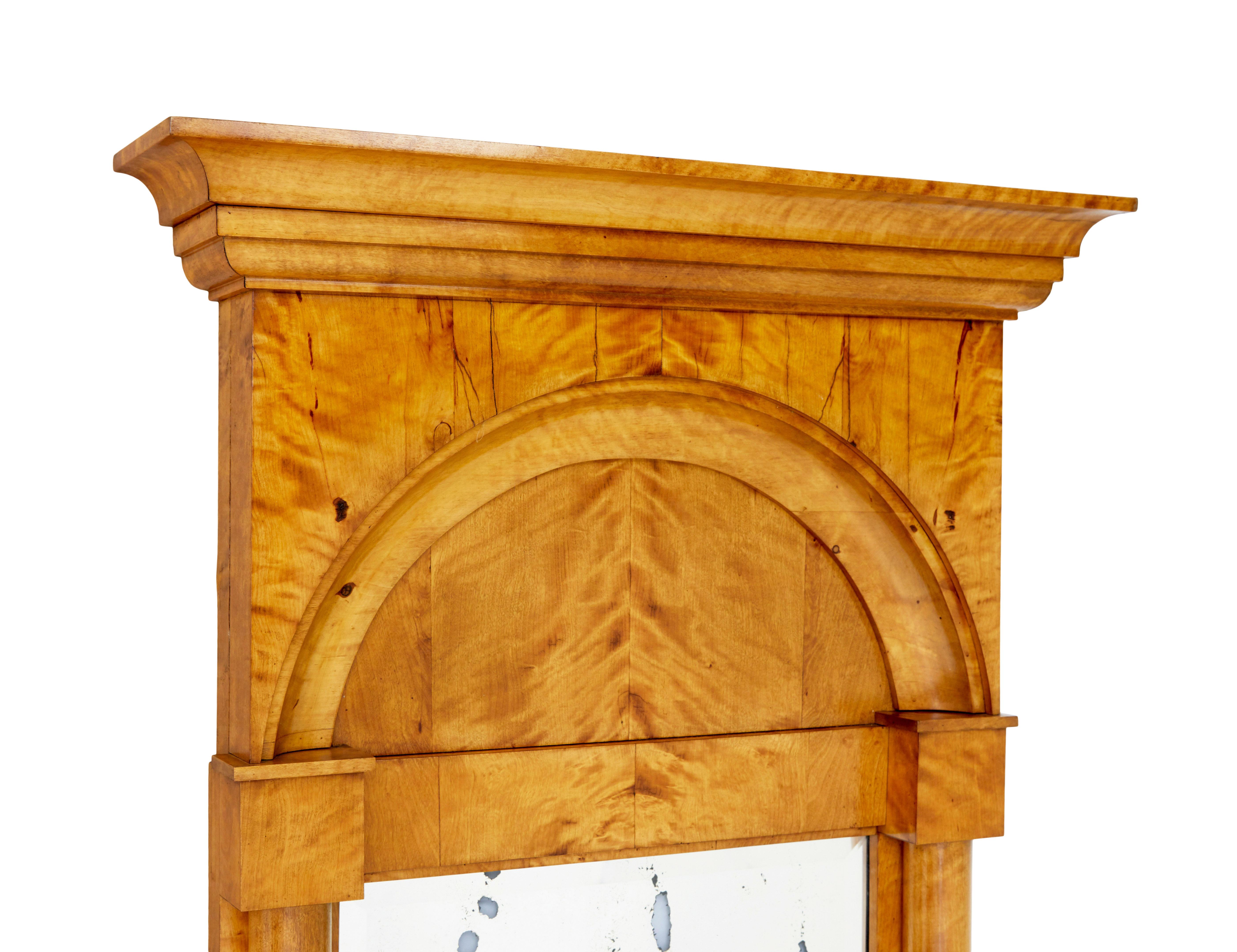 Late 19th century Swedish empire revival birch pier mirror circa 1890.

Fine architectural pier mirror made in birch.

Rich golden empire revival birch, with architectural cornice.  Moulded arch which links the 2 columns that flow down either side