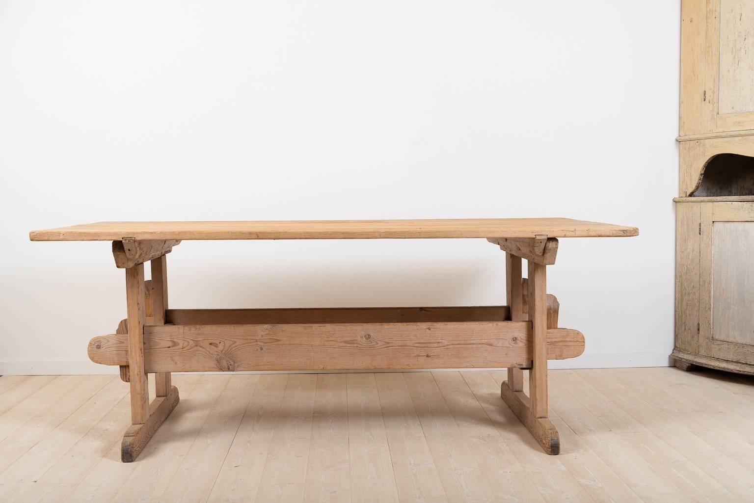 Trestle table from northern Sweden manufactured circa 1810. The table is in good condition and is complete. All parts are original to the table, even the four wedges are originals from the early 1800s; the condition is very good with whole and