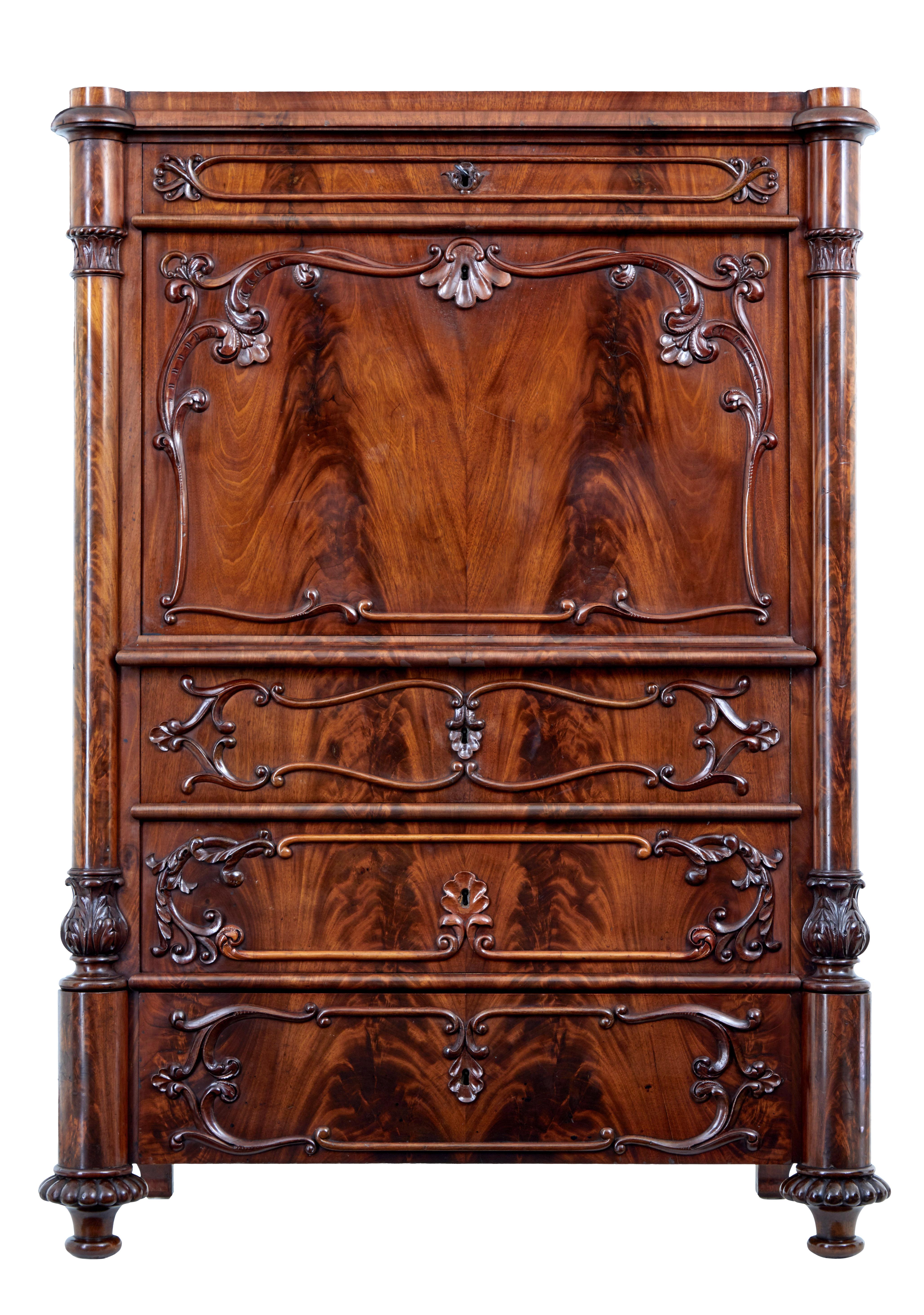 Fine quality Swedish made mahogany secrétaire, circa 1870.

Beautifully applied matched flame mahogany veneers. Single top drawer, with fall below followed by a further 3 drawers all flanked each side by a column each side with carving.

Fall