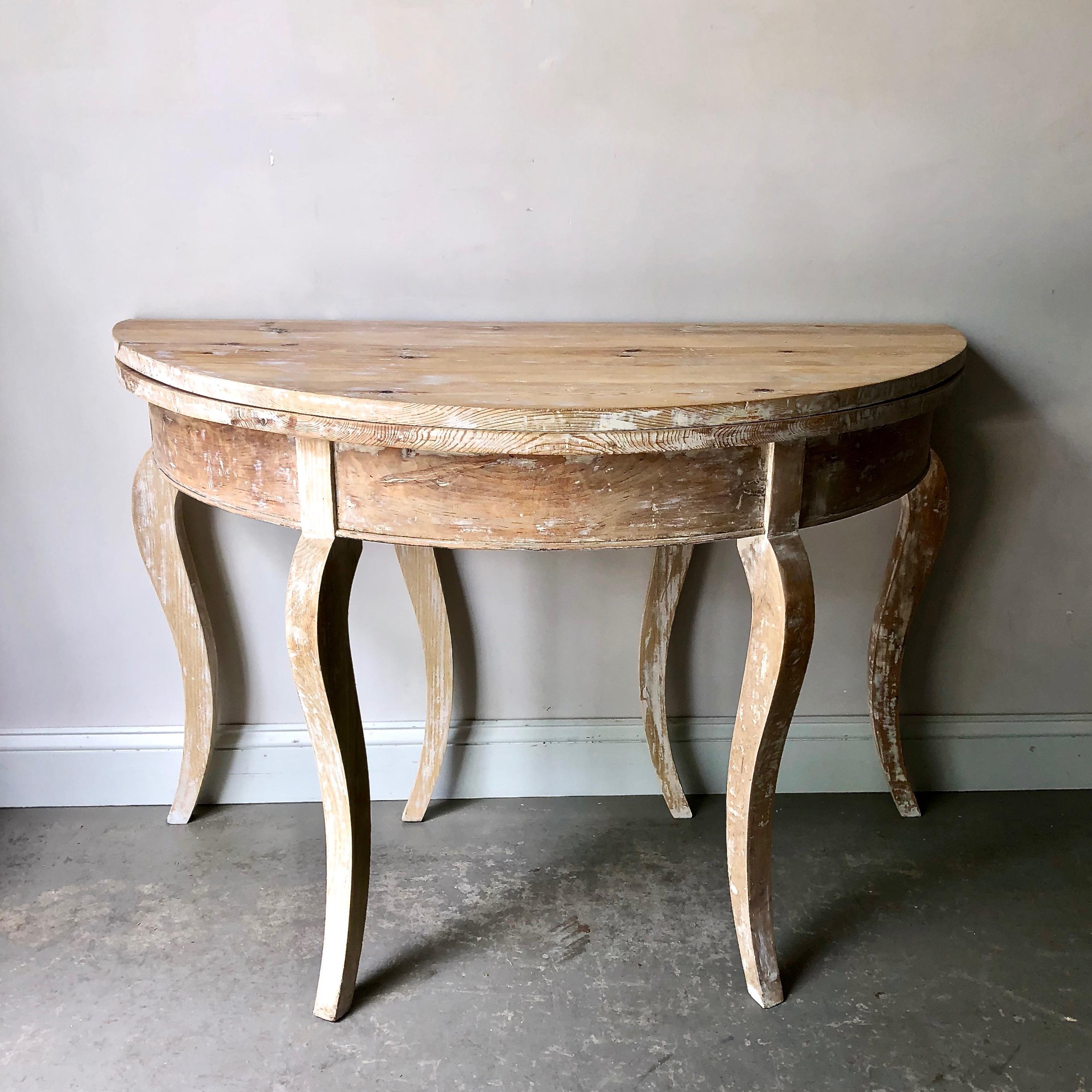 Swedish demilune folding table with delicate cabriole legs in Rococo style and layers of paints scraped to original color, Sweden, circa 1850. Diameter when open 46.50