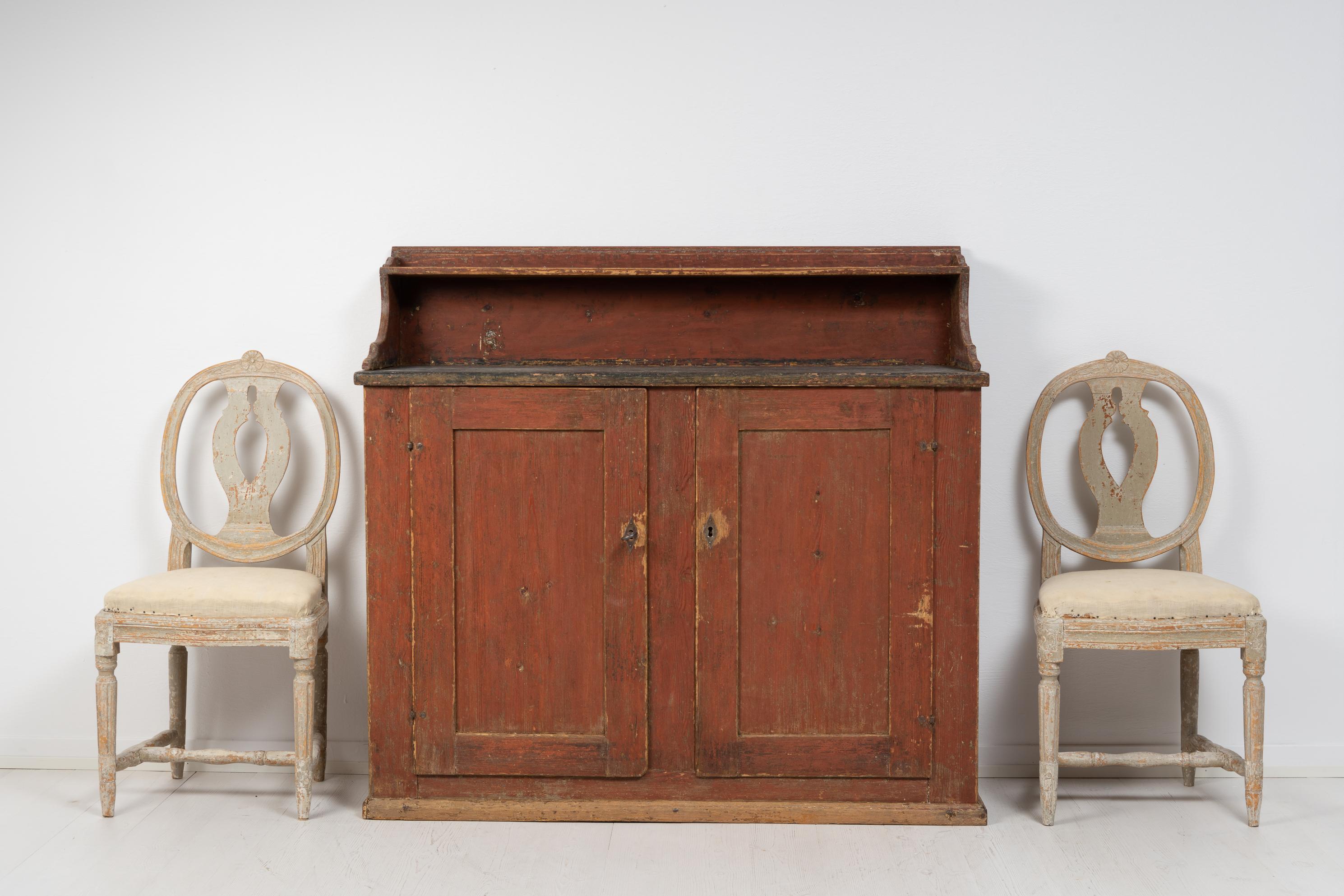 Folk art country sideboard from northern Sweden made during the early 1800s, around 1820 to 1840. The sideboard is painted pine with the original paint and authentic distress of time. The patina is genuine to the sideboard and adds a wealth of