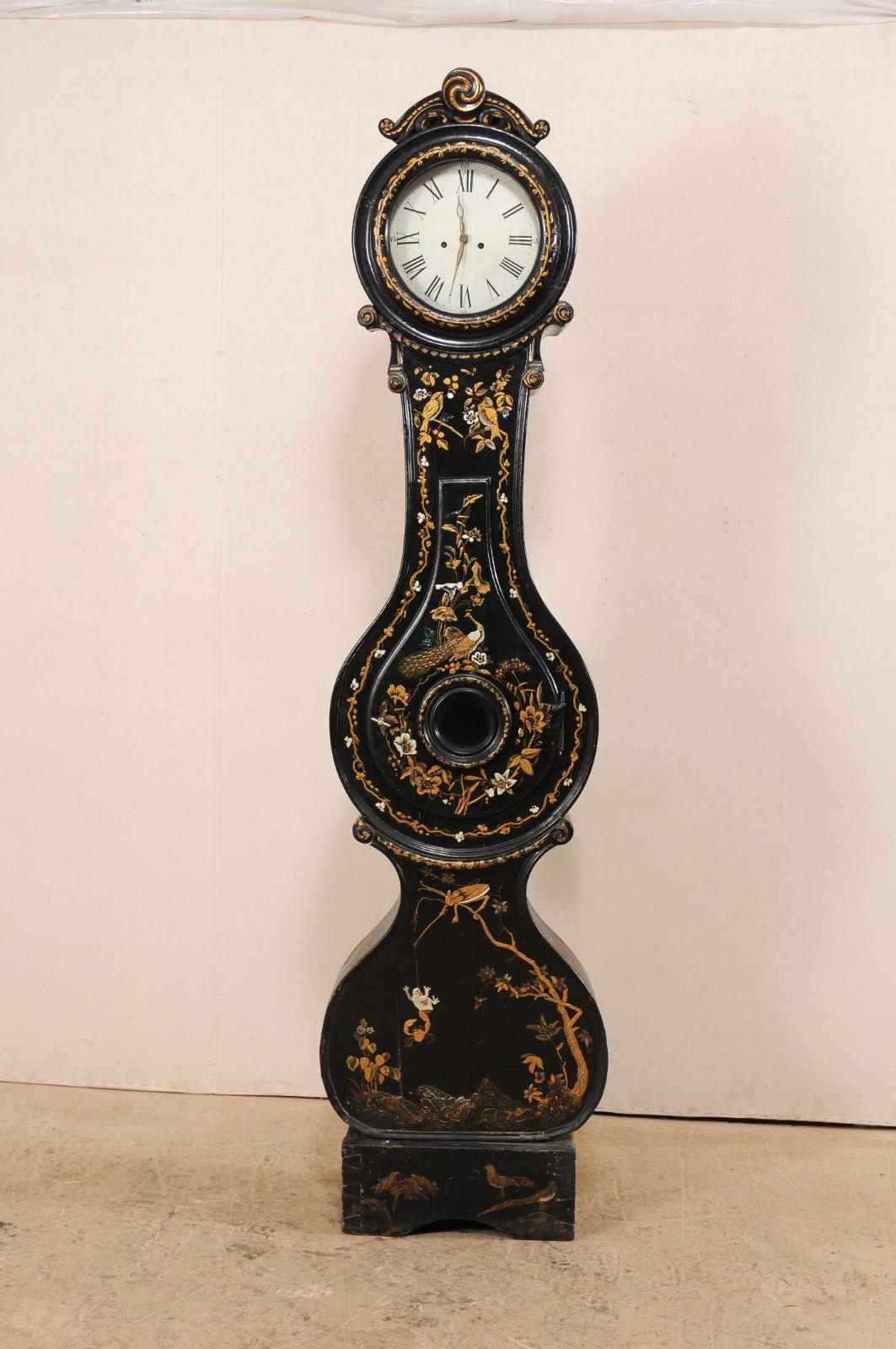 An elegant 19th century Swedish Fryksdahl clock adorn with distinctive chinoiserie nature design and abalone inlay. This antique Fryksdahl clock from Sweden is loaded with decorative chinoiserie throughout, in a playful nature motif of peacocks,