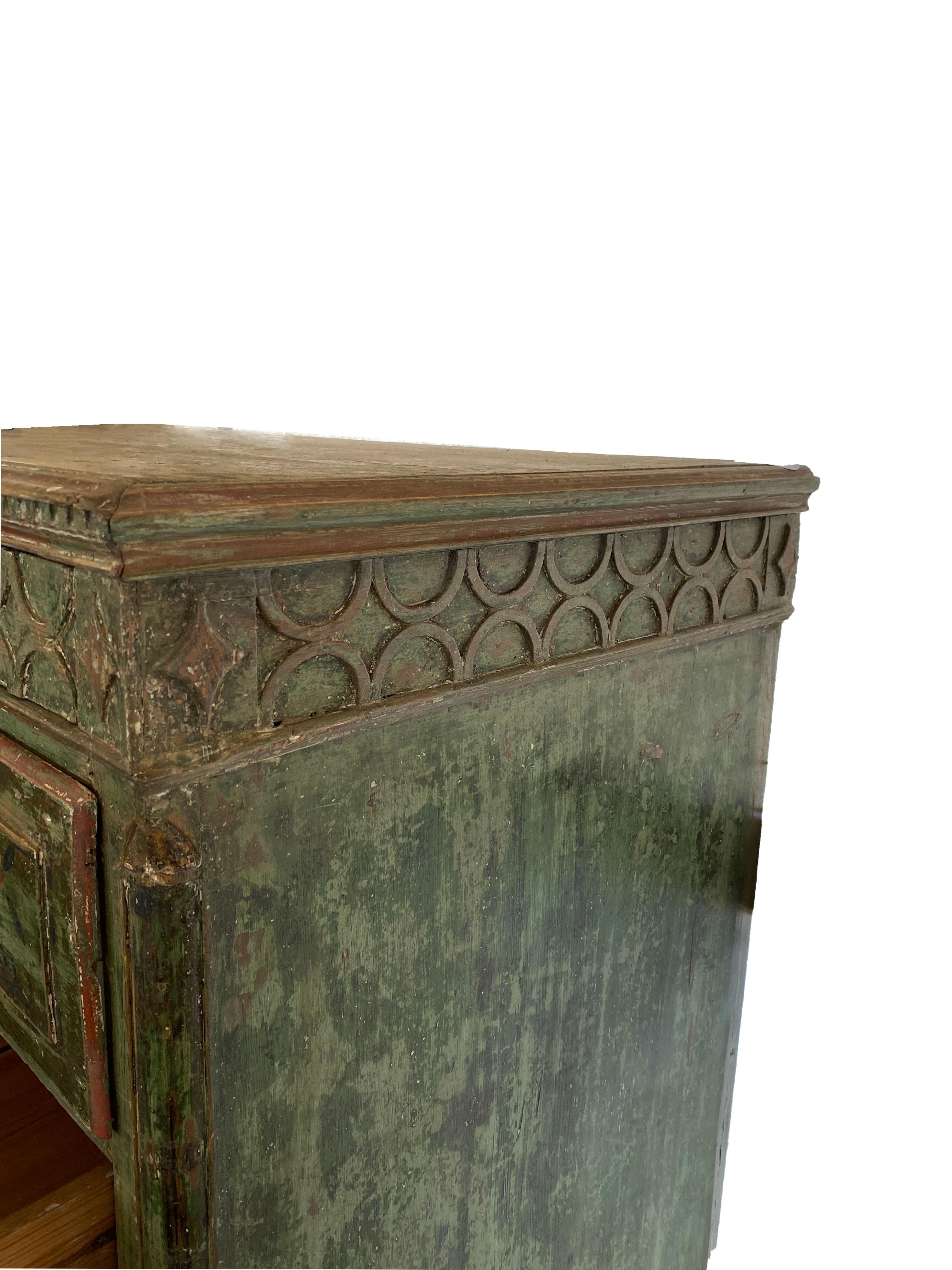This exquisite Swedish gustavian period chest of drawers is rare and unusual for its period. Its green color is original and full of patina and layered depth. Each drawer has its own key for opening. A dental detail runs just above the top small
