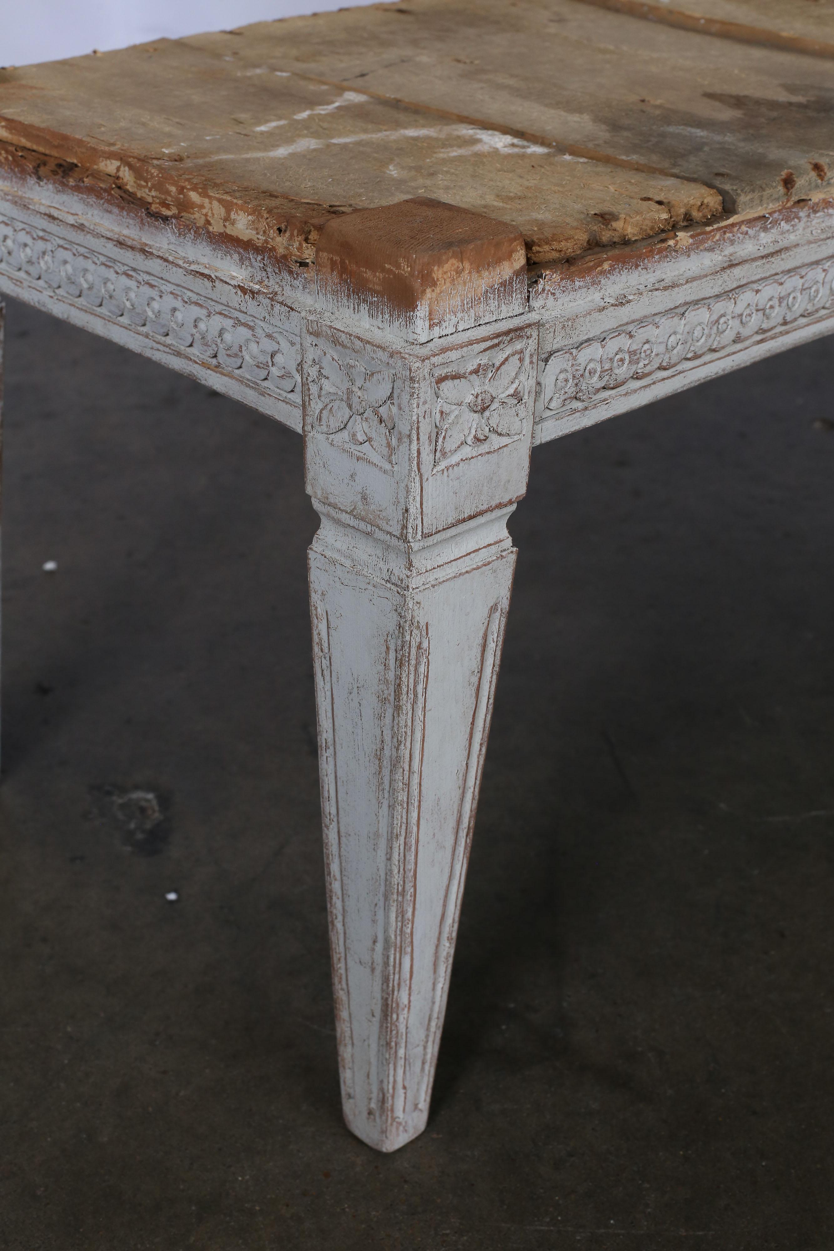 19th century Swedish Gustavian bench with carving around all sides and tapered square legs.