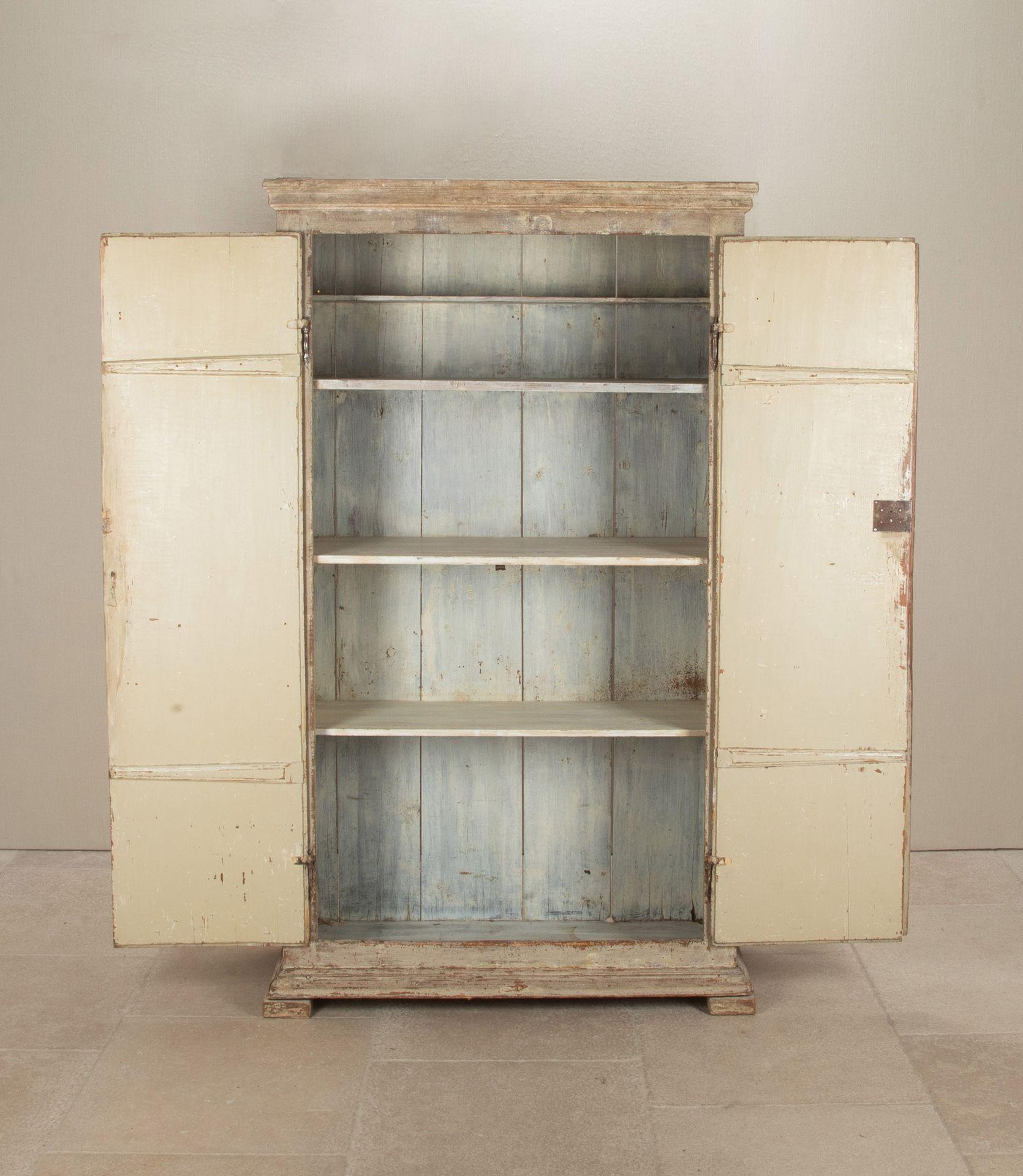 Early 19th Century Swedish Gustavian cupboard with reeded doors and original paint. Circa 1820.