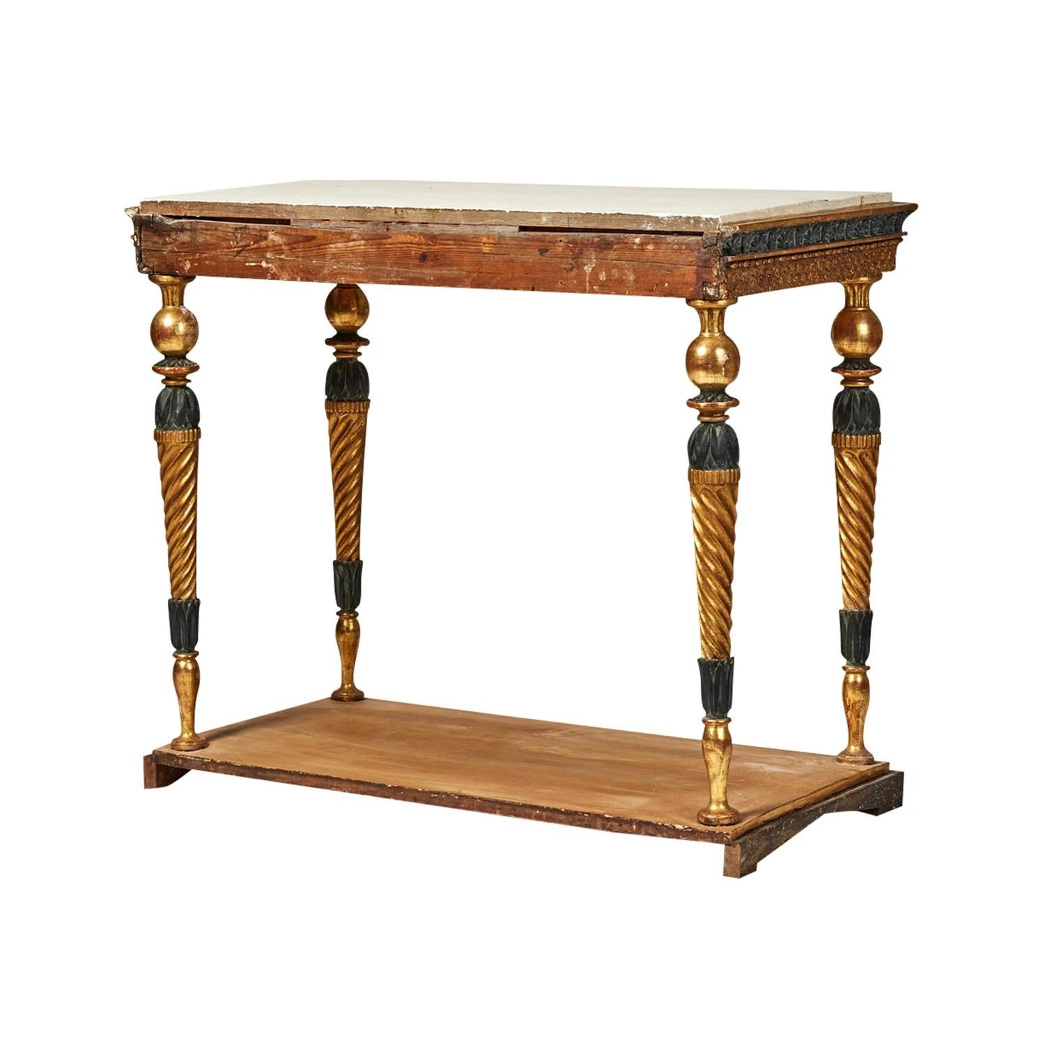 A gold, antique Swedish Gustavian freestanding console table made of hand crafted gilded Pinewood with a white-grey painted marble top, designed and produced most likely by Jonas Frisk in good condition. The edges, borders of the Scandinavian side