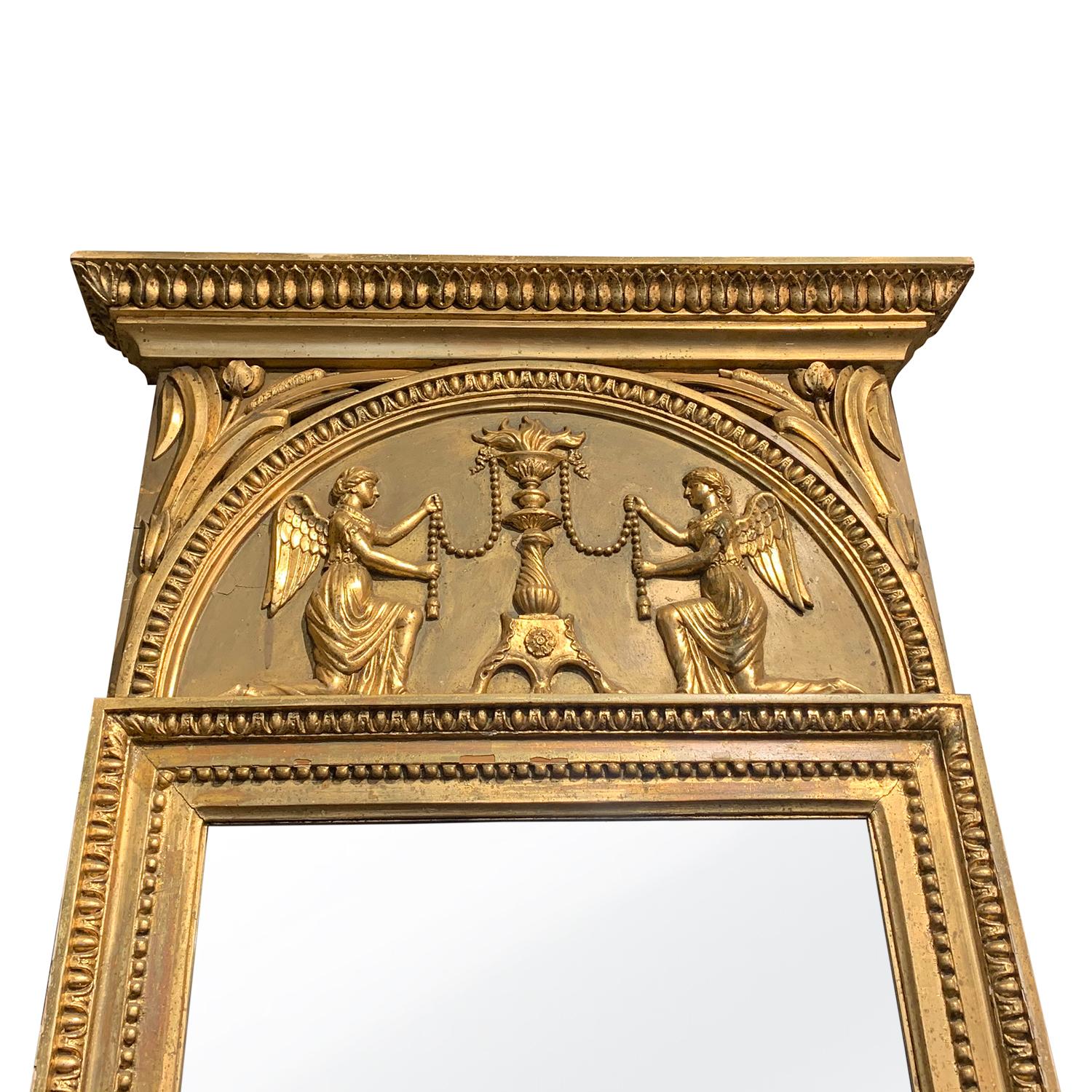 A gold, antique large late Swedish Gustavian wall mirror with a gilded frame and original glass, enhanced by detailed wood carvings with two angles, in good condition. Wear consistent with age and use. Circa 1800 Stockholm, Sweden, Scandinavia.