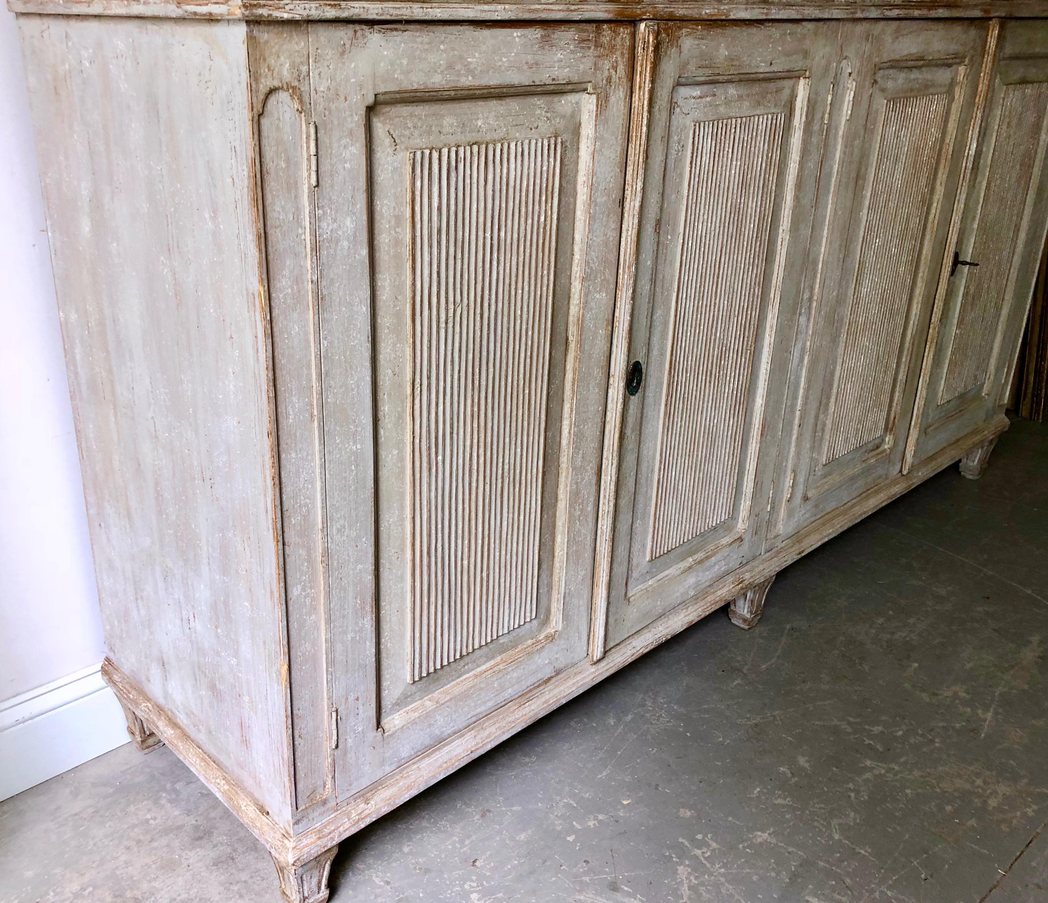 An elegant Gustavian four-door sideboard with beautifully carved, reeded and paneled door fronts. 
Stockholm, Sweden, circa 1840. 
Here are few examples surprising pieces and objects, authentic, decorative and rare items that you will only see in